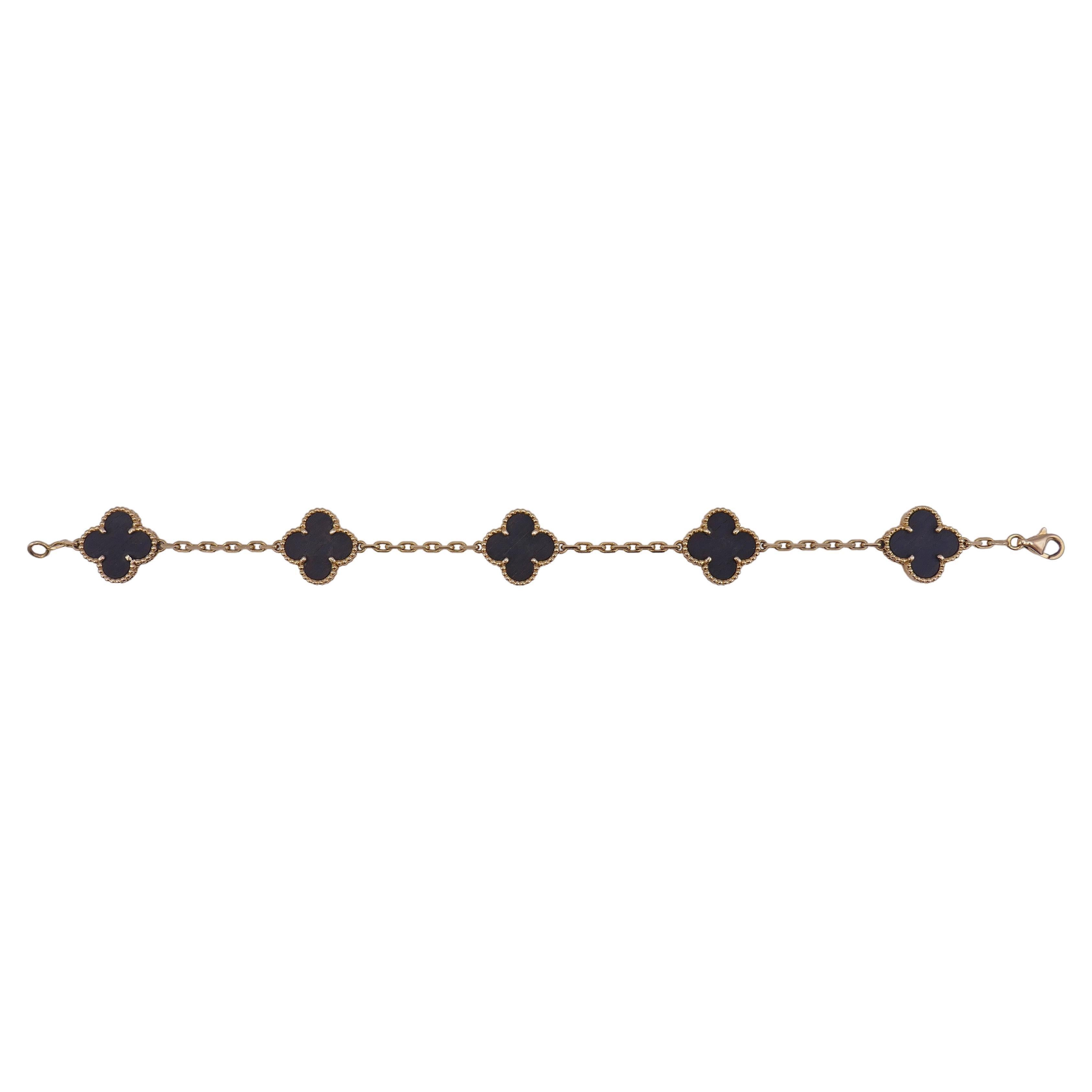 A five yellow gold clover motifs inlaid with letterwood bracelet from Vintage Alhambra collection by Van Cleef & Arpels. The iconic Alhambra design is embodied in a delicate bracelet and stays timeless throughout the years.
Alhambra is the general