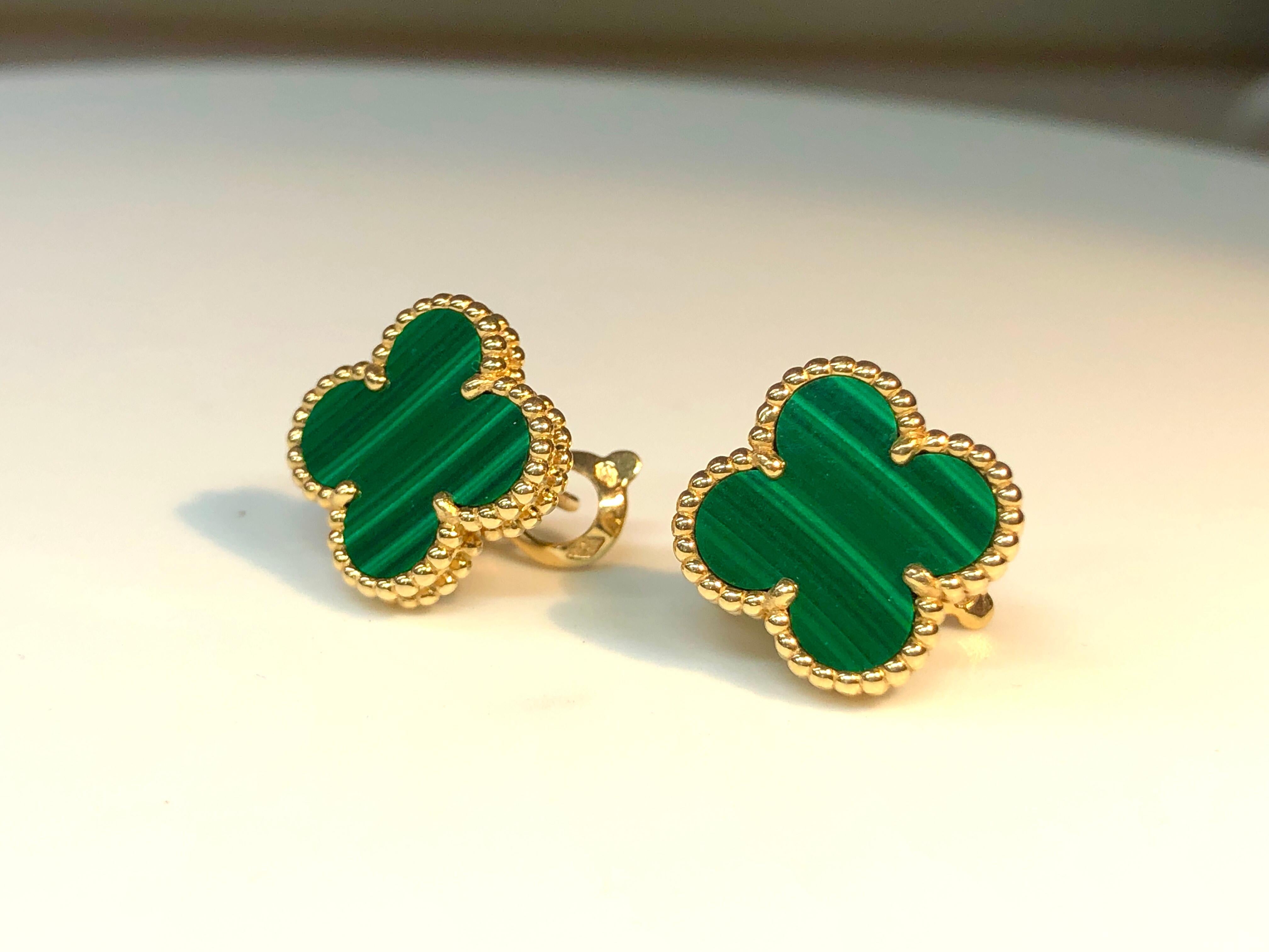 Vintage Alhambra earrings set in 18k yellow gold with malachite clover motifs. Inspired by the clover leaf, these icons of luck are adorned with a border of golden beads. 
The earrings come in a VCA Pouch. Original certificate of authenticity.
