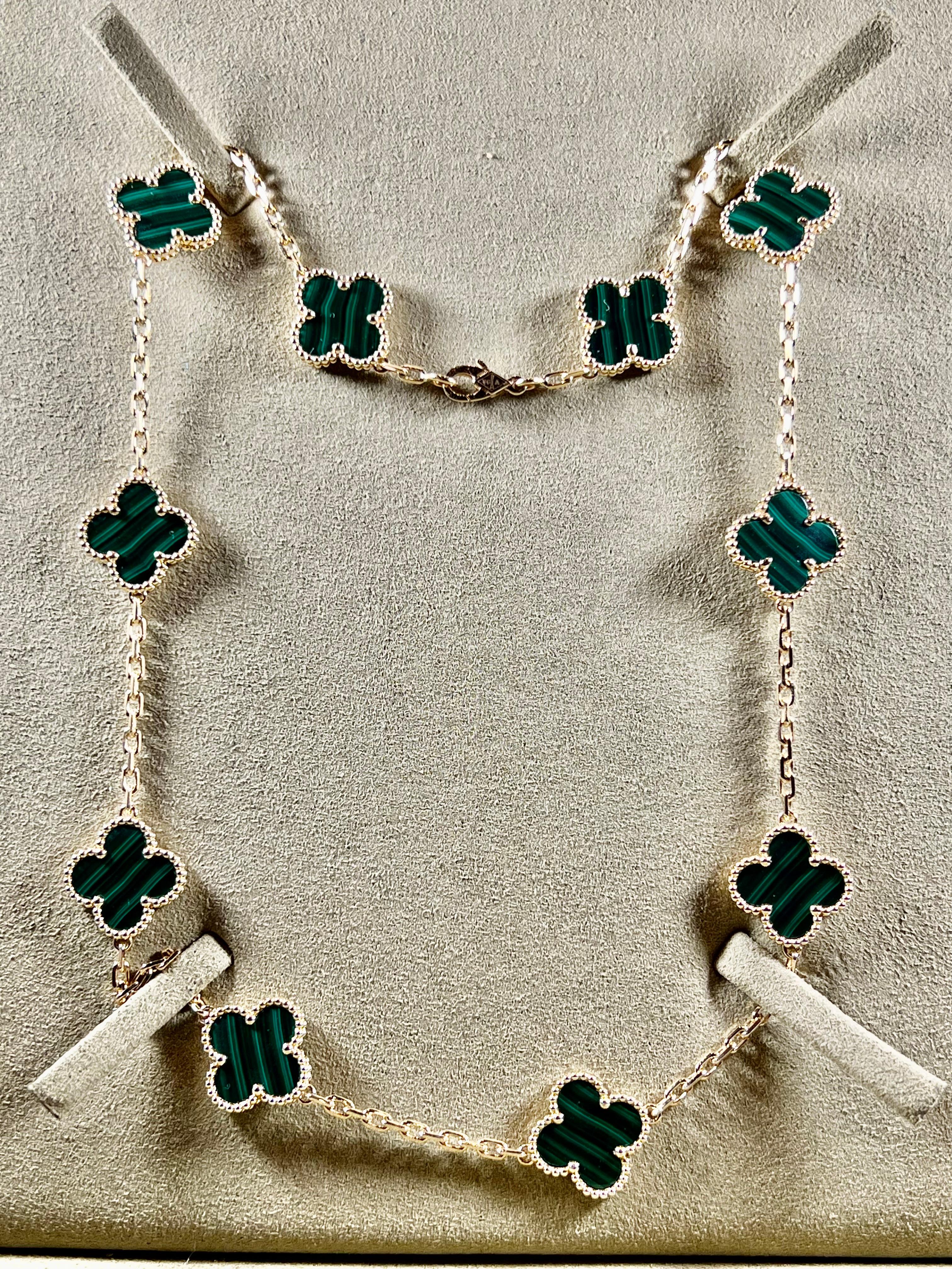 This classic vintage Van Cleef & Arpels necklace is crafted in 18k yellow gold and features 10 lucky clover motifs inlaid with green malachite in round bead settings. Made in France circa 2000. Measurements: 0.59