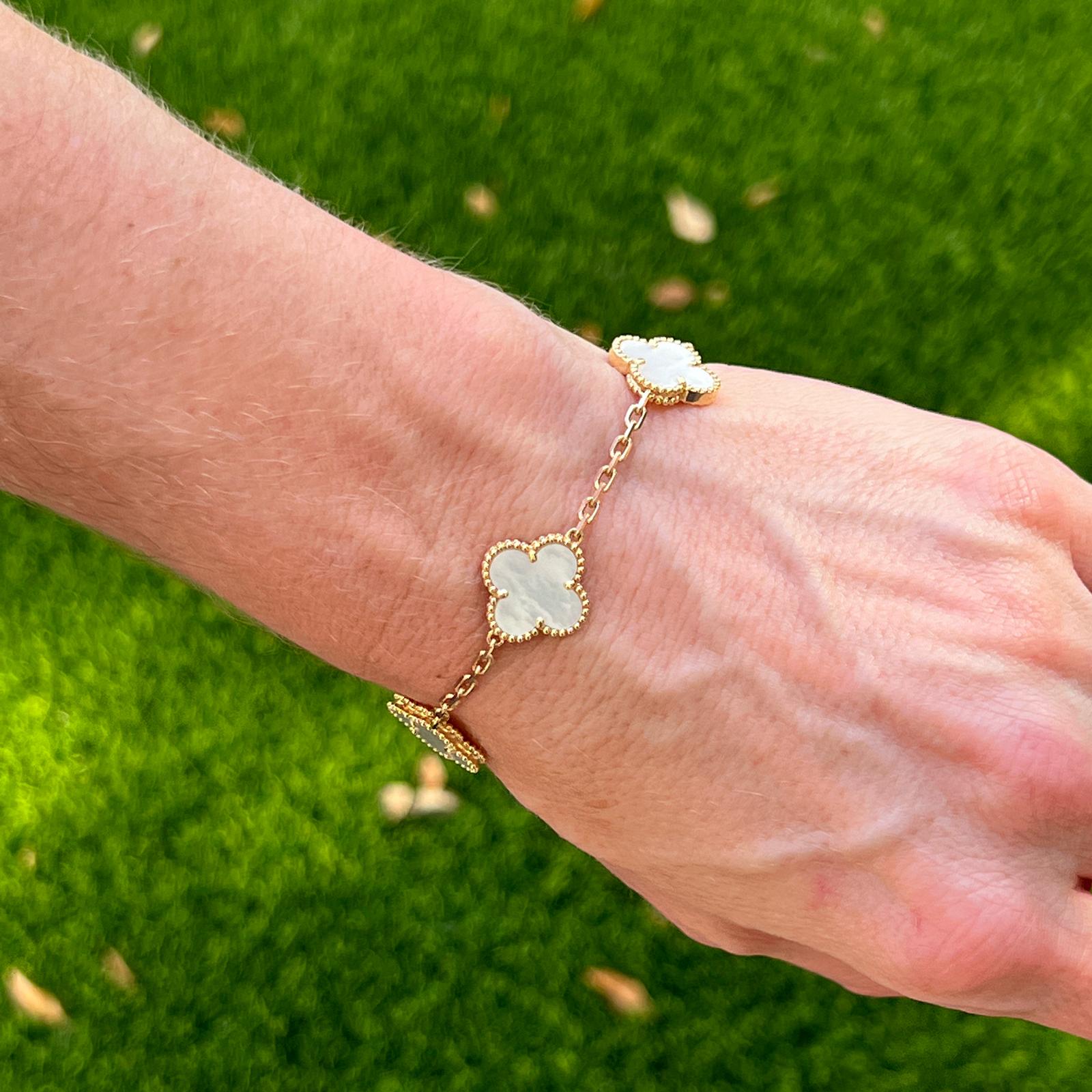 Authentic Van Cleef & Arpels Vintage Alhambra Mother of Pearl bracelet fashioned in 18 karat yellow gold. The 5 motif bracelet was originally purchased in 2019. The bracelet measures 7.5 inches in length and is signed, numbered, and hallmarked.