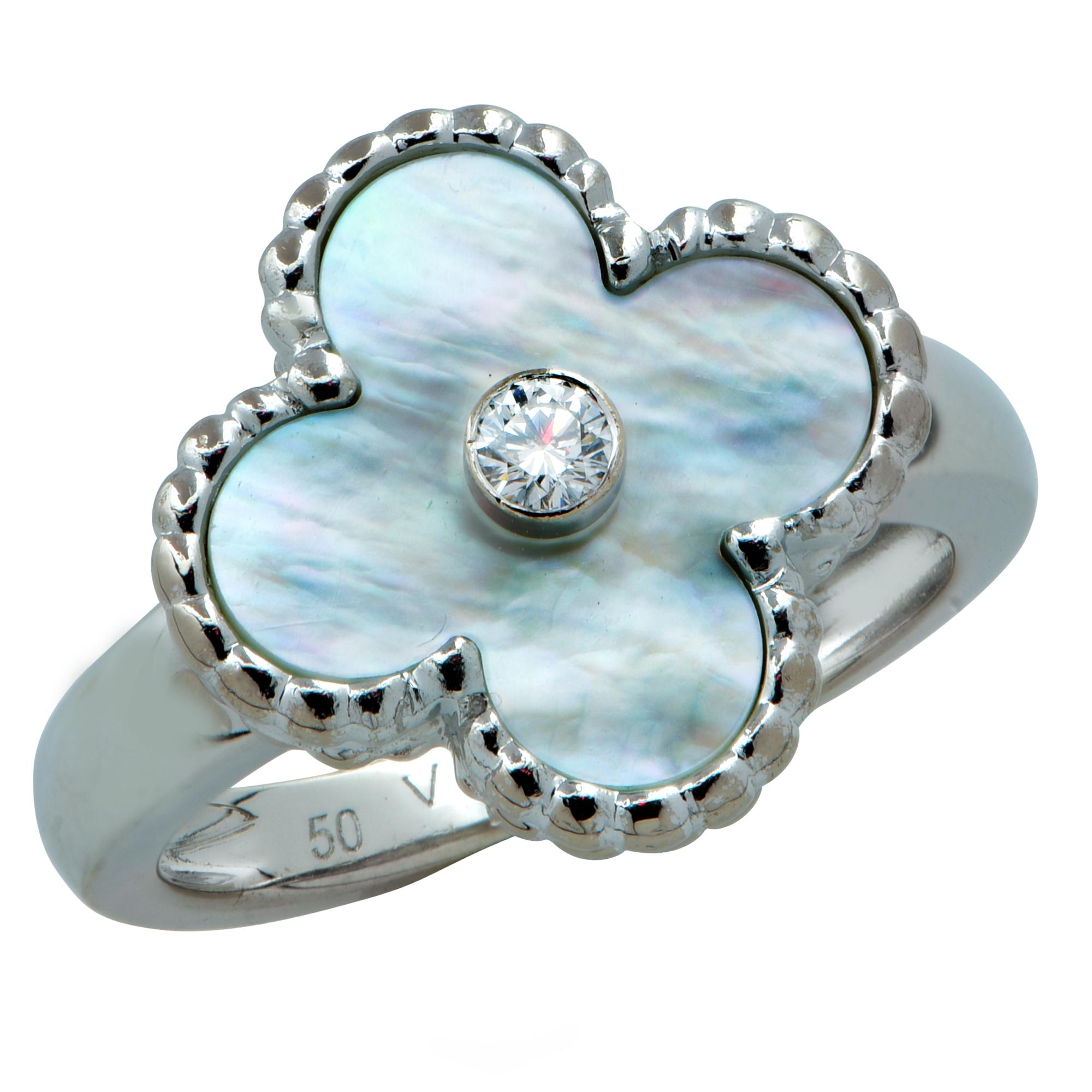 This stunning Van Cleef & Arpels Vintage Alhambra ring crafted in18 Karat white gold features a white mother-of-pearl motif inspired by the clover leaf, embellished with a round brilliant cut diamond weighing approximately .06cts, F color VVS