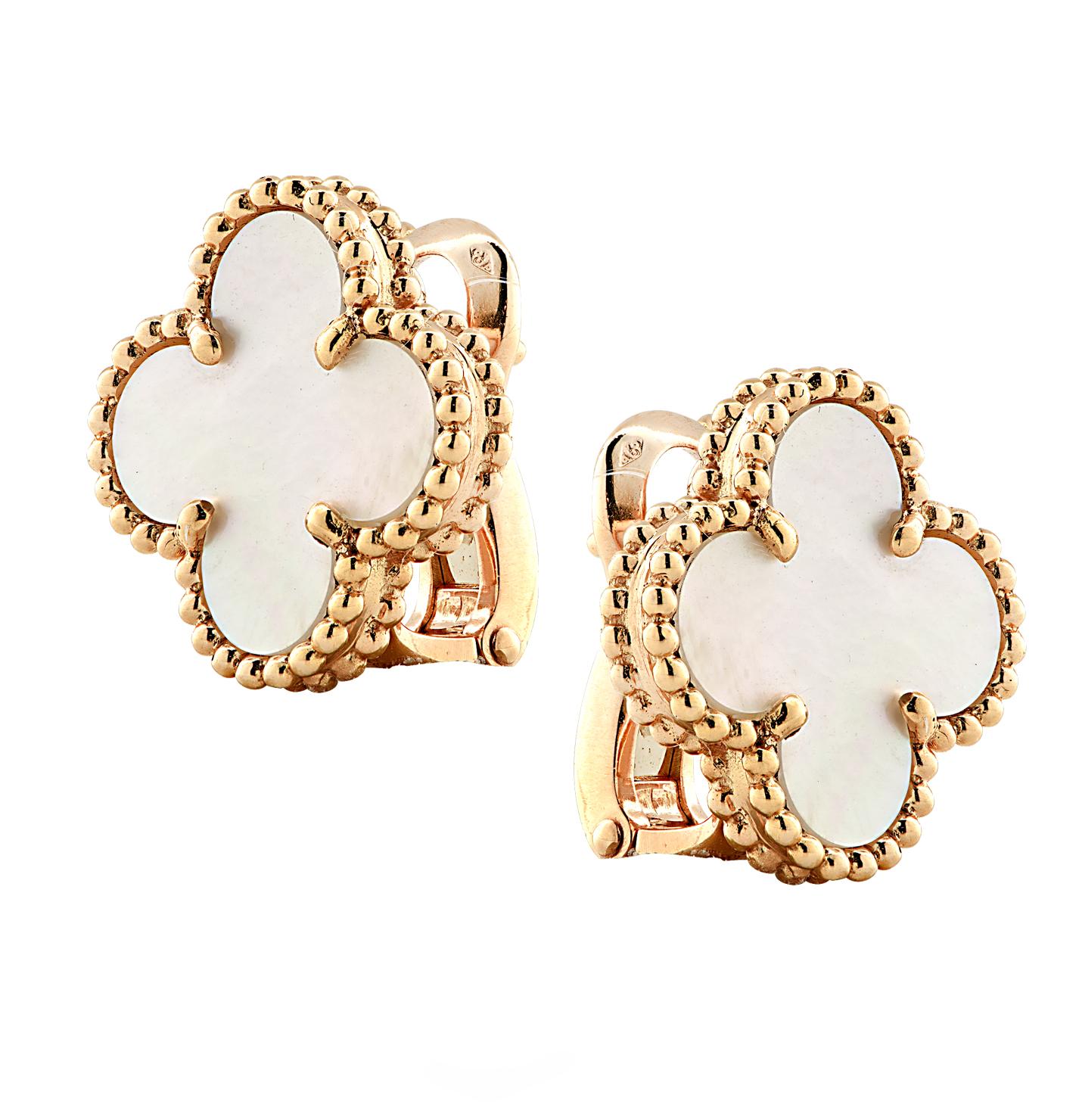 From the House of Van Cleef & Arpels, these exquisite Vintage Alhambra earrings, finely handmade in 18 Karat yellow Gold, feature a symmetrical design inspired by the clover leaf. The clovers are embellished in mother of pearl and are framed in gold