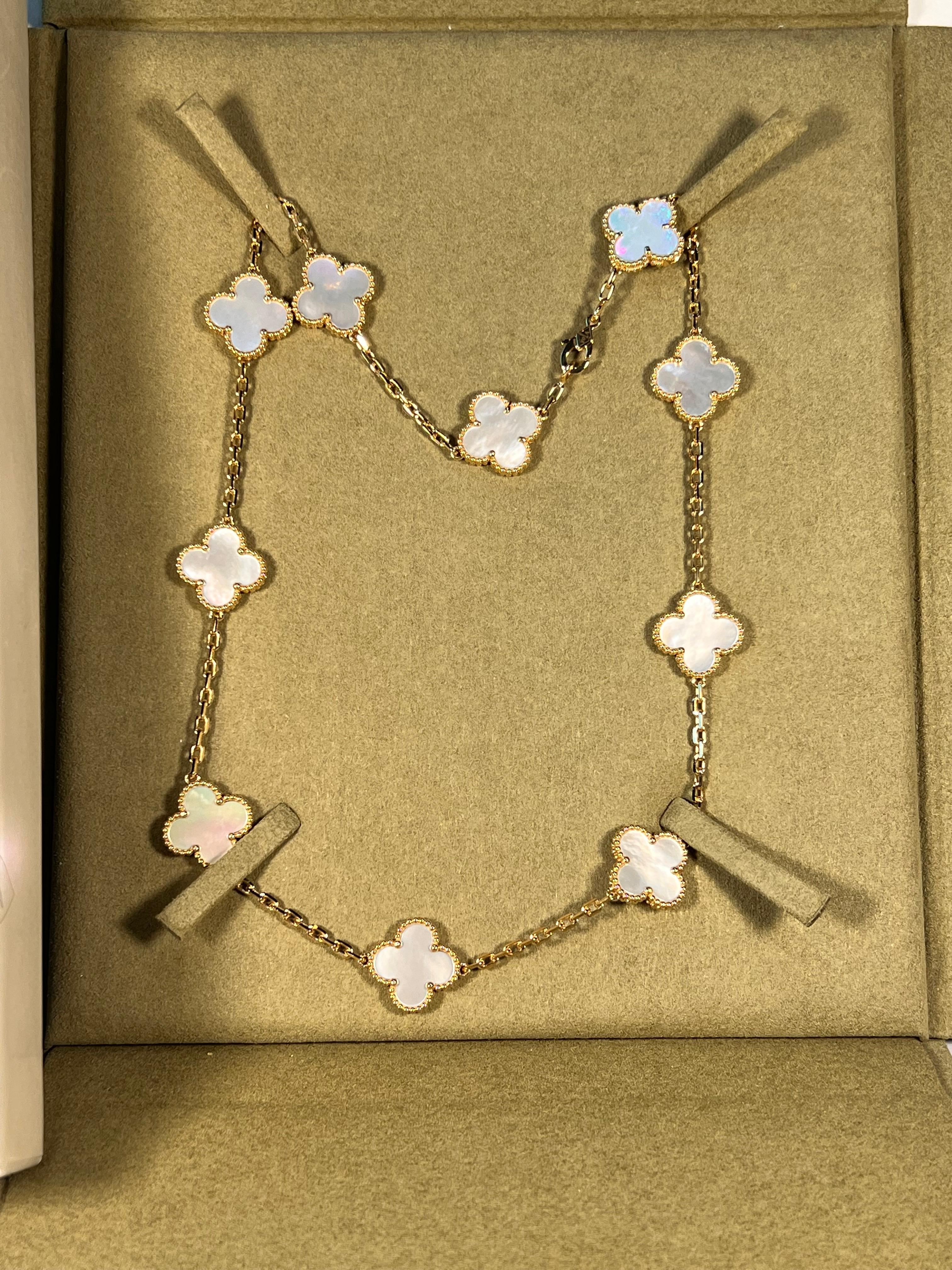 This classic vintage Van Cleef & Arpels necklace is crafted in 18k yellow gold and features 10 lucky clover motifs inlaid with mother of pearl  in round bead settings. Made in France circa 2000. Measurements: 0.59