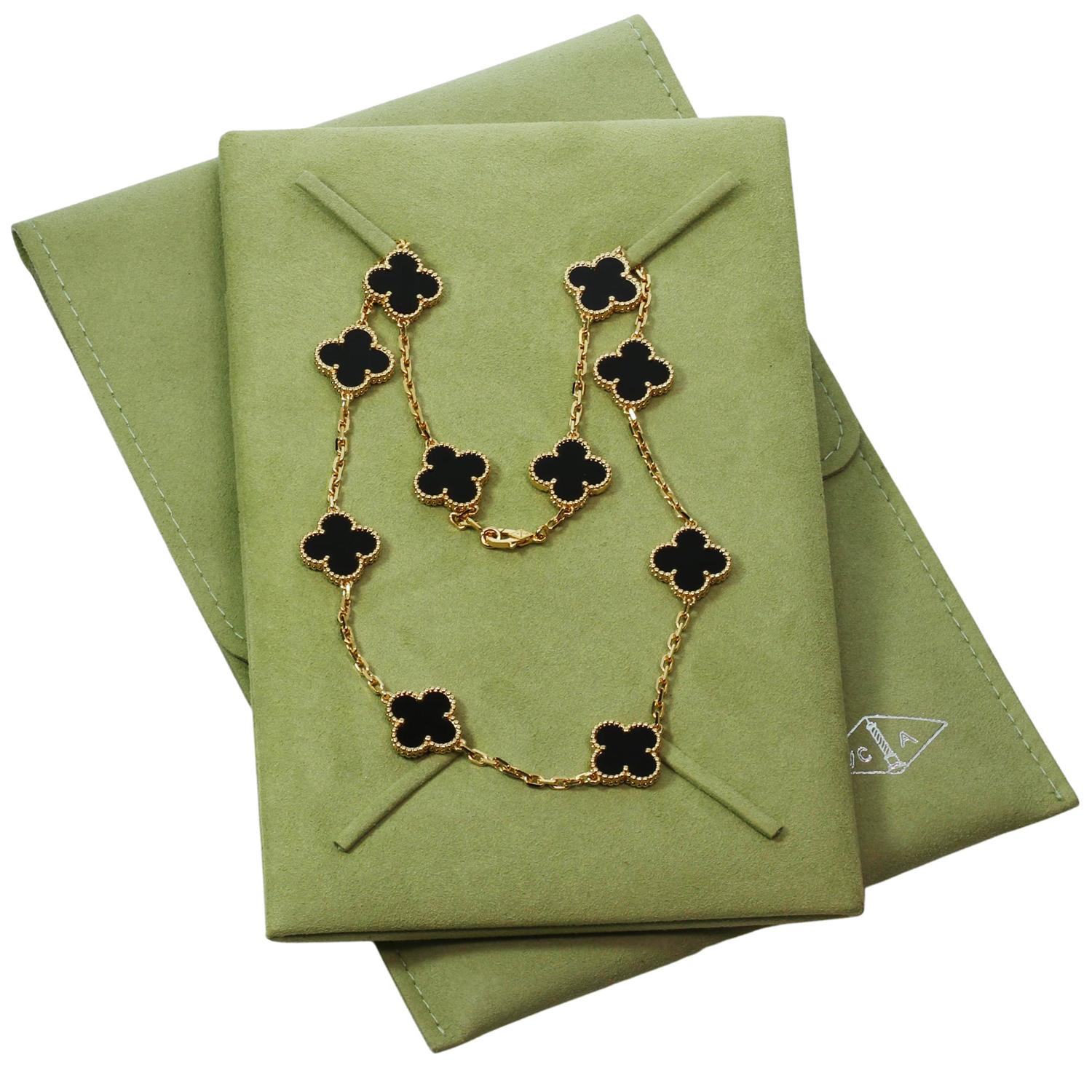 This classic Van Cleef & Arpels necklace is crafted in 18k yellow gold and features 10 lucky clover motifs elegantly inlaid with onyx in round bead settings. Made in France circa 2010s. Measurements: 0.59