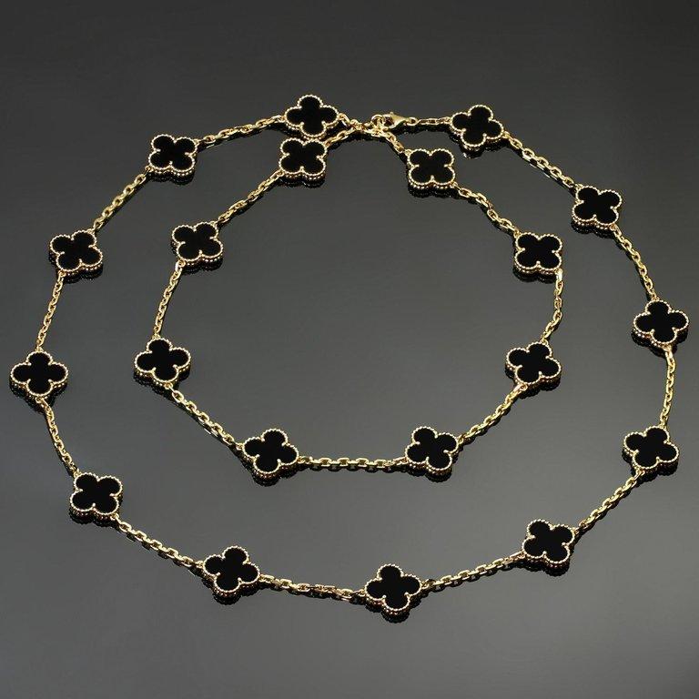 This classic long Van Cleef & Arpels necklace from the iconic Vintage Alhambra collection is crafted in 18k yellow gold and features 20 lucky clover motifs beautifully inlaid with black onyx in round bead settings. Made in France circa 2012.
