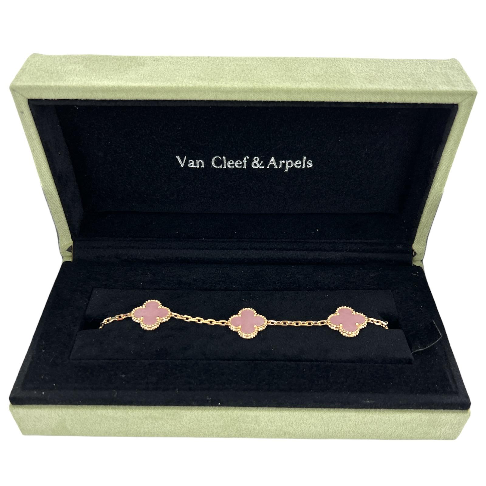 Van Cleef & Arpels Vintage Alhambra Pink Opal Bracelet fashioned in 18 karat yellow gold. This rare collectors piece is retired from the collection. The 5 motif bracelet is 7 inches in length, signed, numbered, and hallmarked. Comes in original box