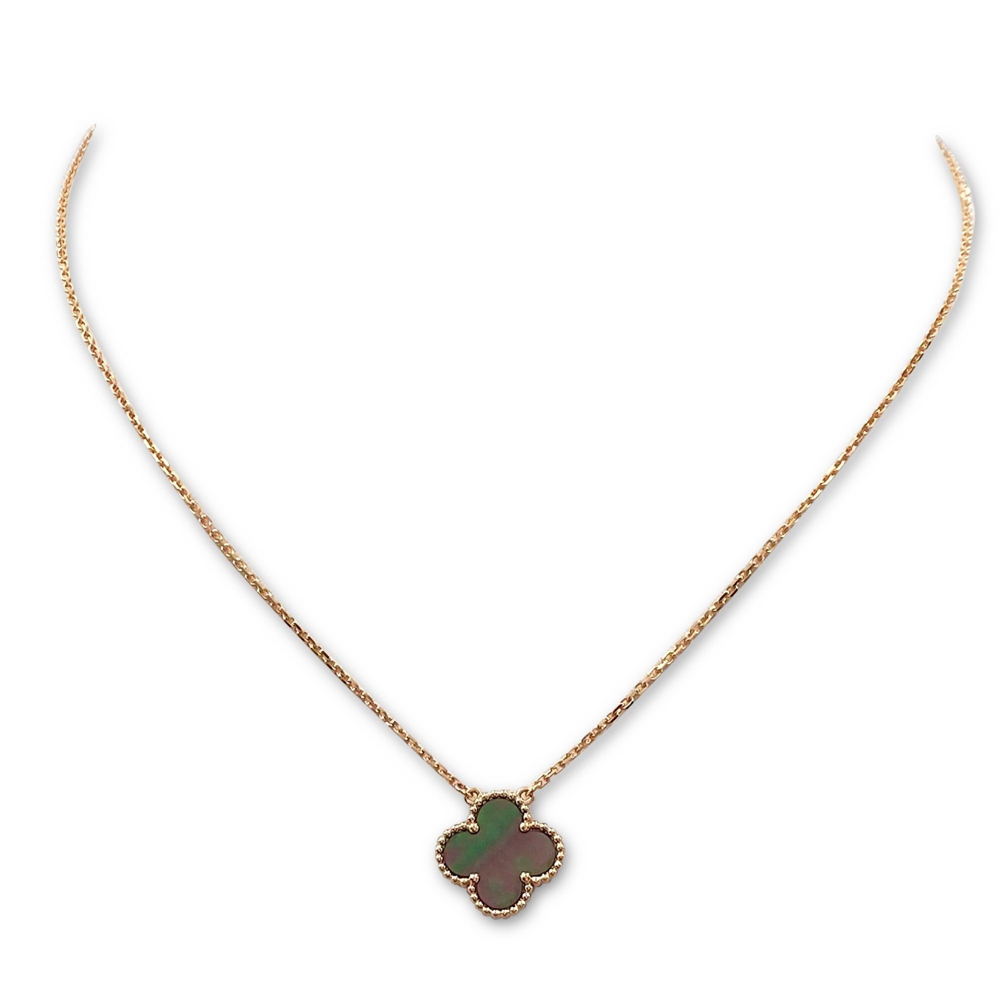 Authentic Van Cleef & Arpels 'Vintage Alhambra' necklace crafted in 18 karat rose gold and featuring one clover-shaped motif in carved mothe of pearl. The pendant hangs from a 16 3/4 inch adjustable chain.  Signed VCA, Au750, with serial number and