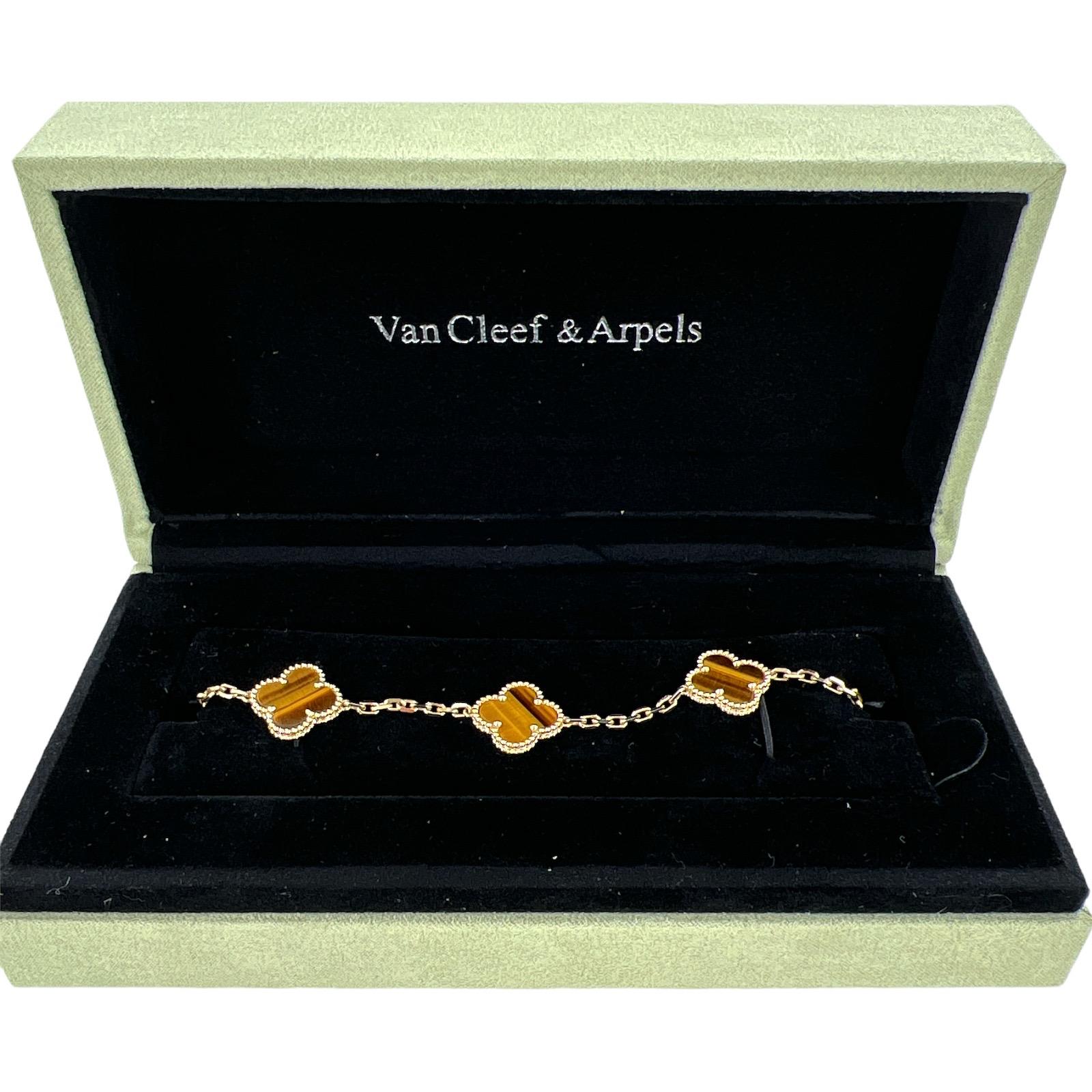 Authentic Van Cleef & Arpels Vintage Alhambra Tiger's Eye bracelet fashioned in 18 karat yellow gold. The 5 motif bracelet was originally purchased in 2015. The bracelet measures 7 inches in length and is signed, numbered, and hallmarked. Original