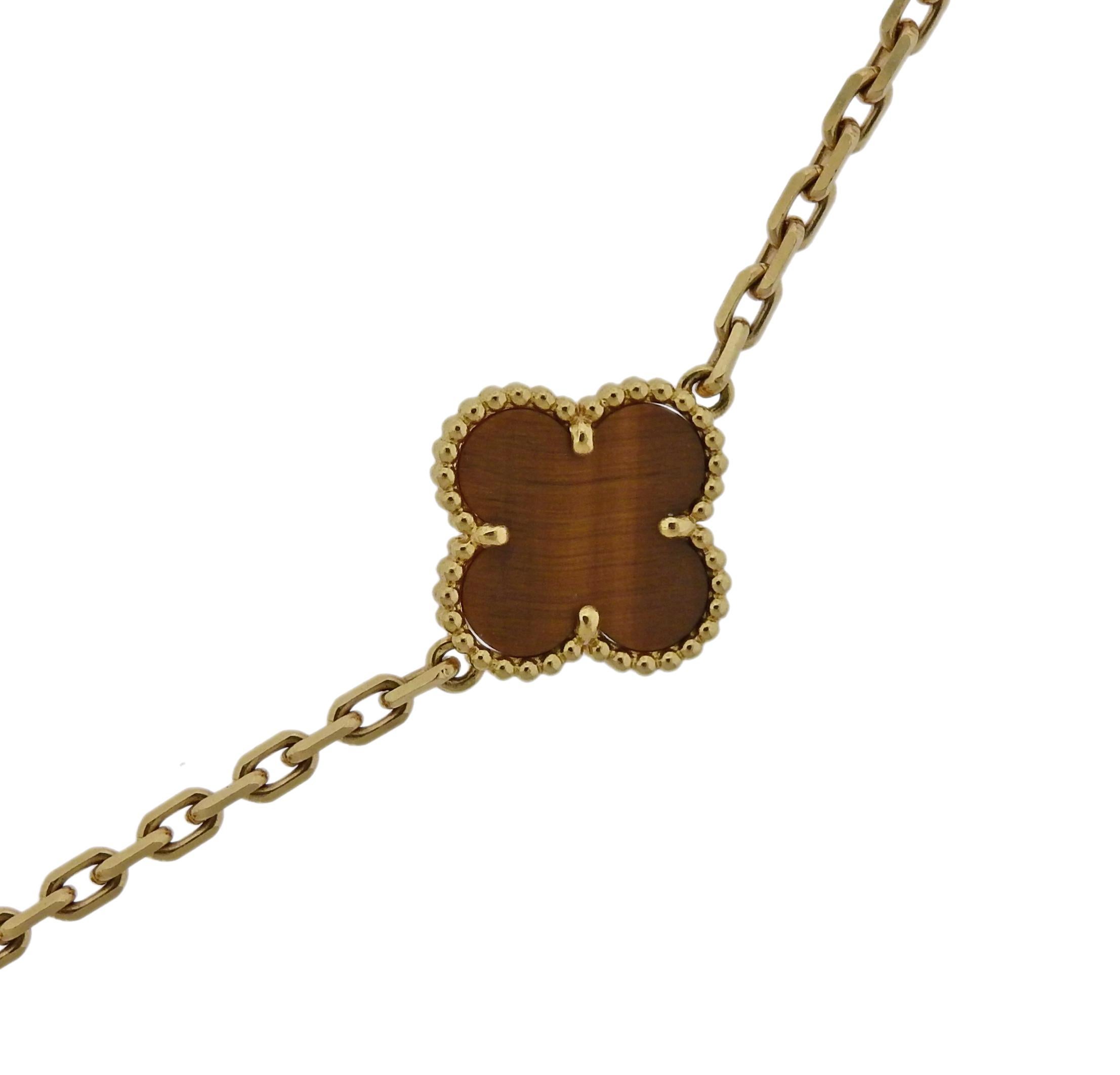 Iconic Vintage Alhambra necklace, featuring twenty tiger's eye clover motifs, set in 18k yellow gold. Retail $16300 + tax.  Necklace is 34