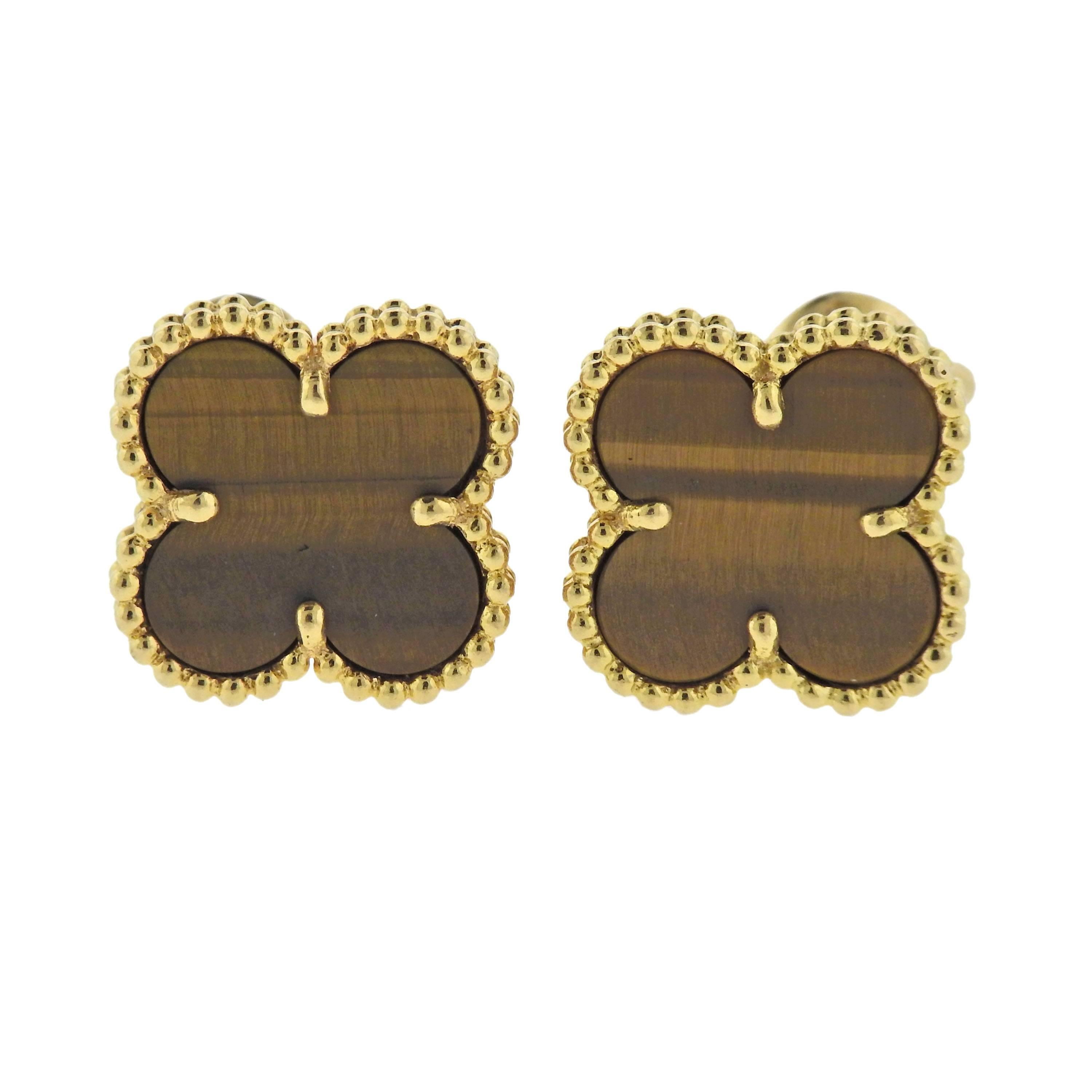  Pair of 18k yellow gold Vintage Alhambra earrings, crafted by Van Cleef & Arpels, set with tiger's eye. Retail for $4150. Earrings 15mm 15mm, weigh 7.1 grams. Marked: VCA, G750, JB147***.