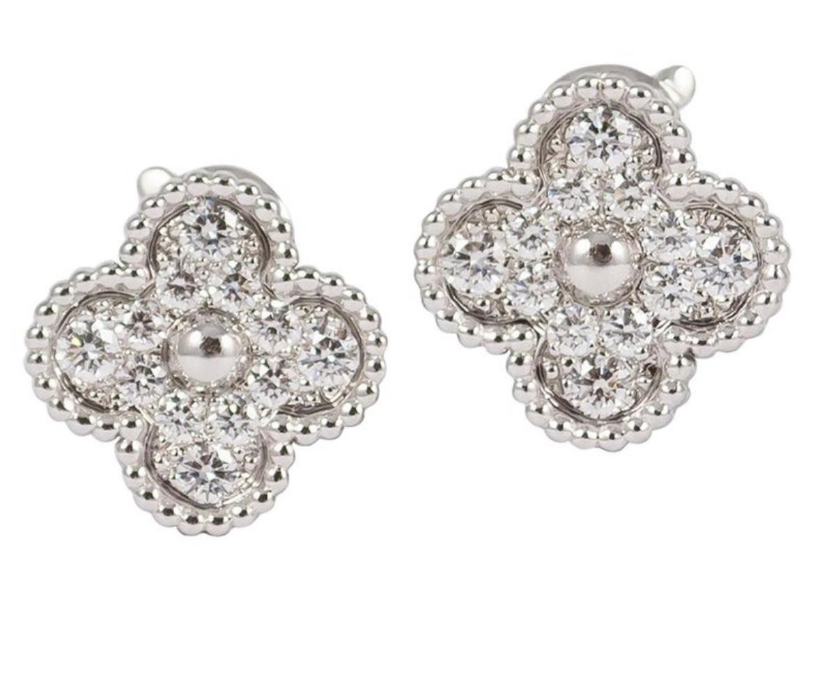 This classic vintage Van Cleef & Arpels earrings are crafted in 18k white gold and feature 2 lucky clover motifs 
Excellent condition
Comes with original case serial number and certificate 
Weight 7.70 gr total 
24 diamonds with a total of .97