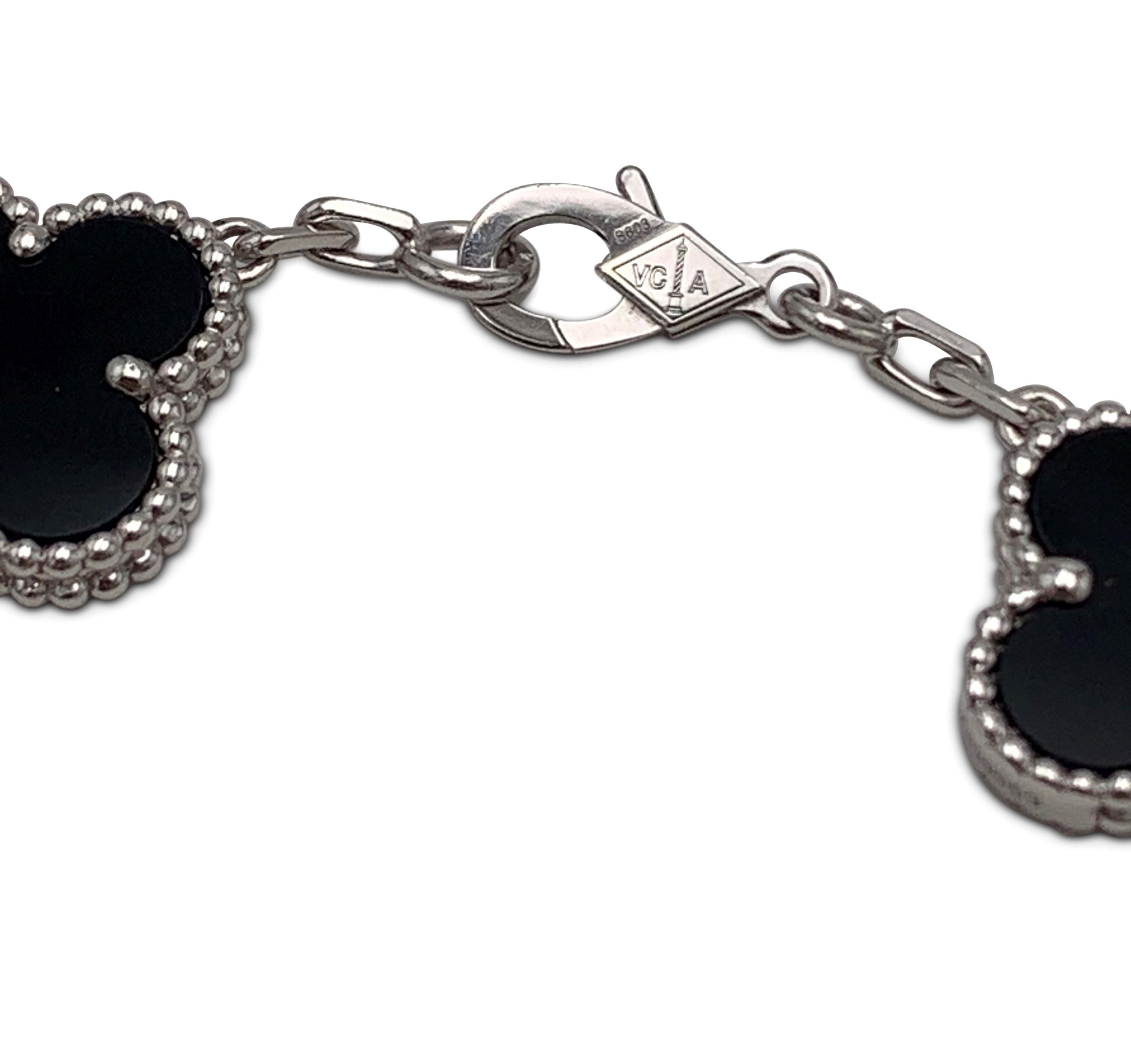 Authentic Van Cleef & Arpels Vintage Alhambra bracelet crafted in 18 karat white gold features alternating clover motifs of onyx and pave diamonds (E-F color, VS clarity) weighing an estimated 0.72 carats total weight.  The bracelet measures 6.5