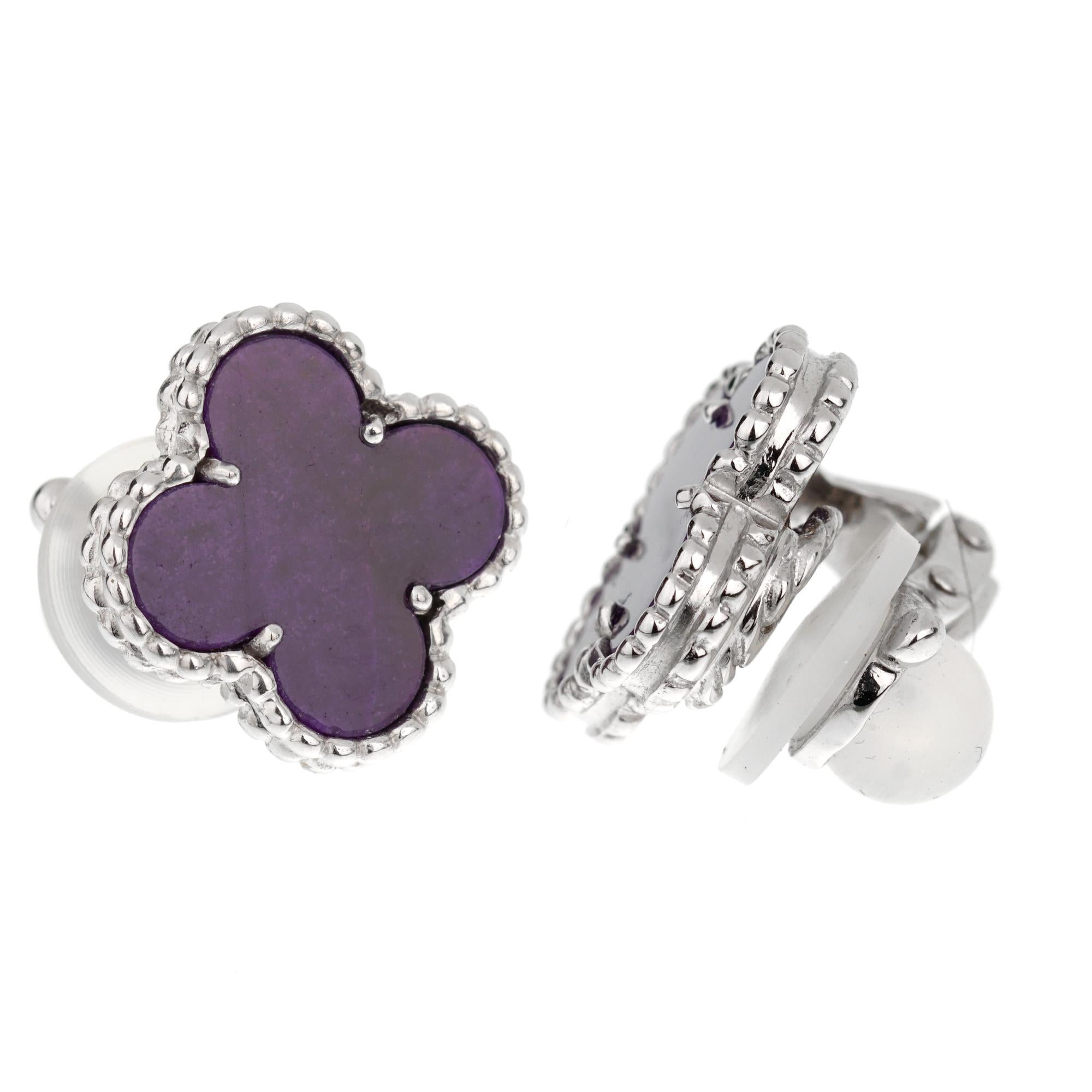 An incredibly rare set of Van Cleef & Arpels earrings showcasing 2 Sugilite stones in the shape of the lucky alhambra motif set in 18k white gold. The earrings are fully hallmarked, Vca, Serial, and 750.