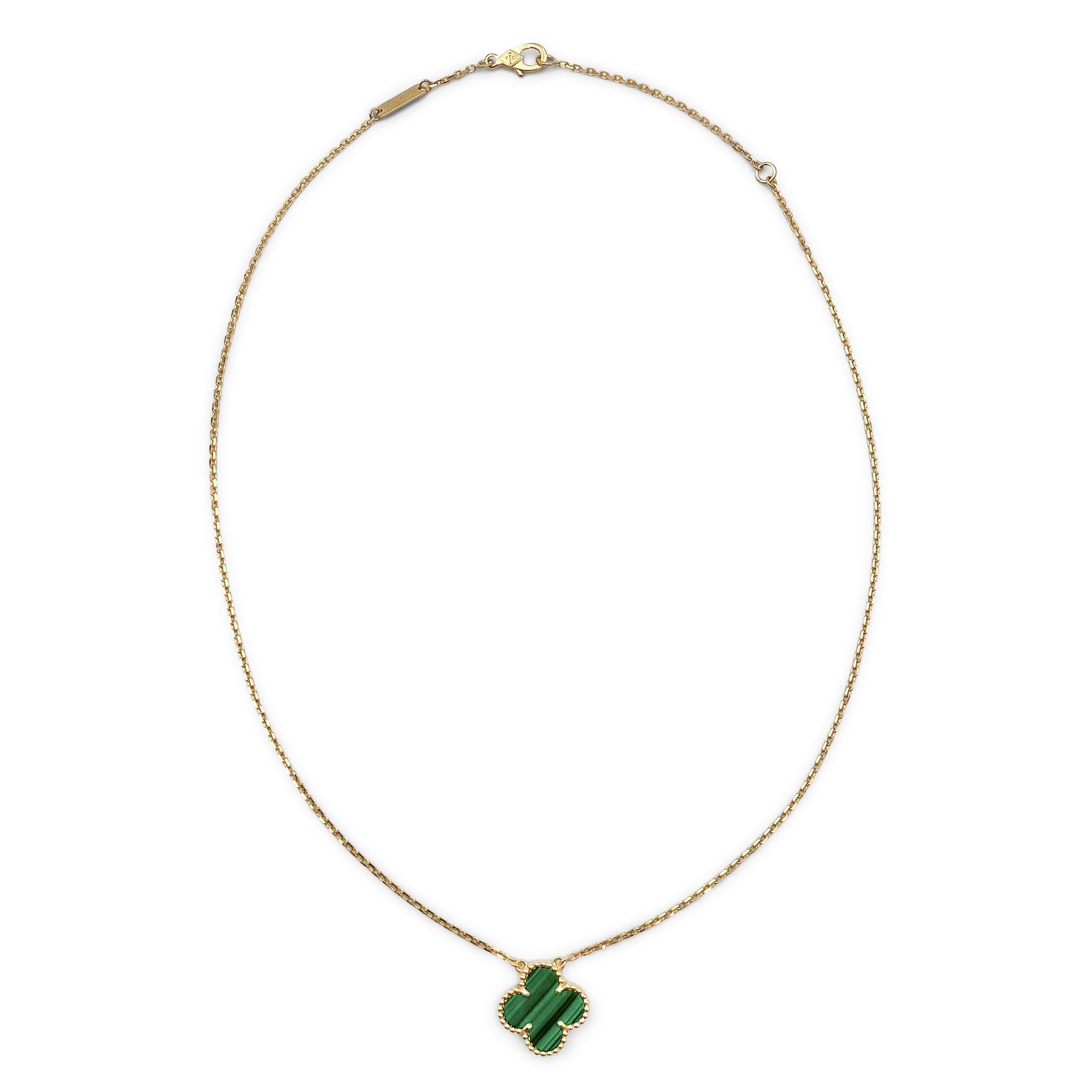 Authentic Van Cleef & Arpels 'Vintage Alhambra' necklace crafted in 18 karat yellow gold and featuring one clover-shaped motif in carved malachite. The pendant hangs from a 16 1/2 inch adjustable chain.  Signed VCA, Au750, with serial number and