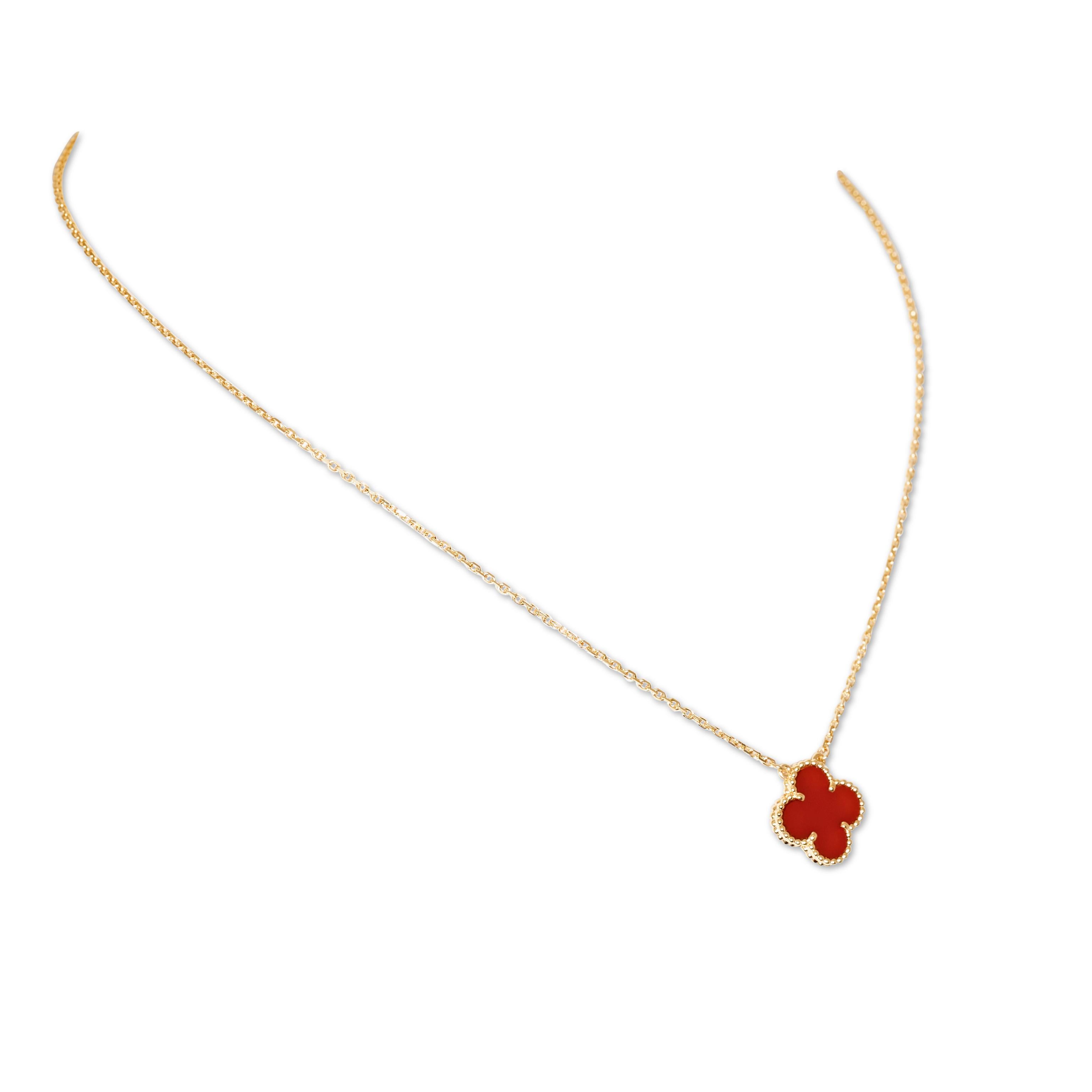 Authentic Van Cleef & Arpels 'Vintage Alhambra' necklace crafted in 18 karat yellow gold and featuring one clover-shaped motif in carved carnelian. The pendant hangs from a 16.5 inch adjustable chain.  Signed VCA, Au750, with serial number and