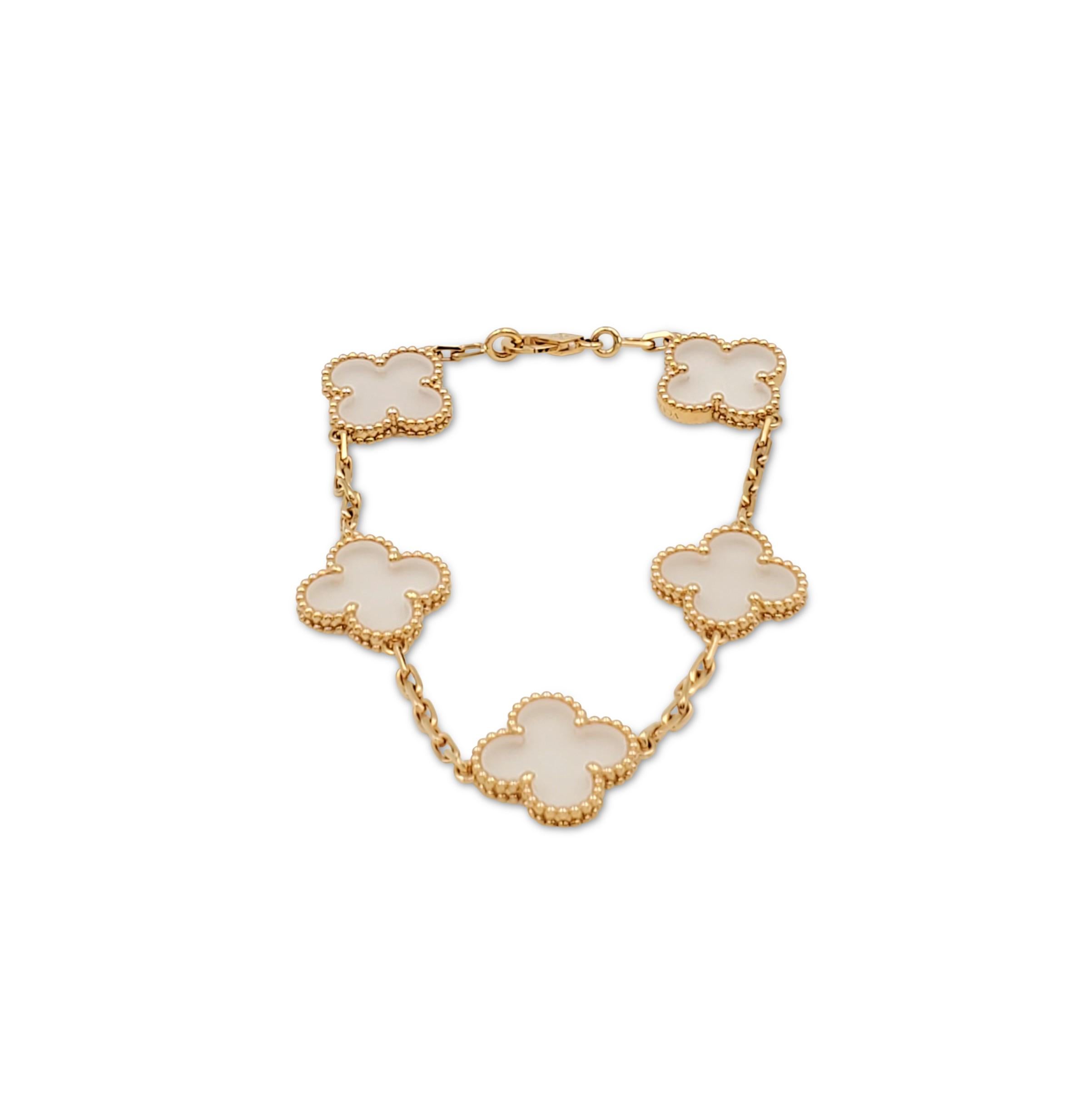 Authentic Van Cleef & Arpels 'Vintage Alhambra' bracelet crafted in 18 karat yellow gold features clover motifs of rock crystal. The bracelet measures 6 1/2 inches in length and is signed VCA, Au750, with serial number and hallmarks. The bracelet is