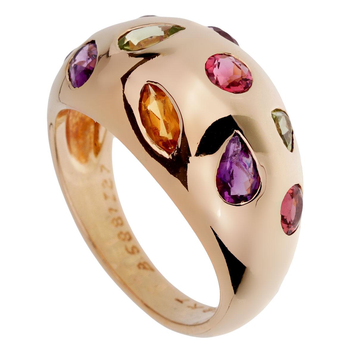 A chic Van Cleef & Arpels ring showcasing multiple gemstones and various shapes in 18k yellow gold. 