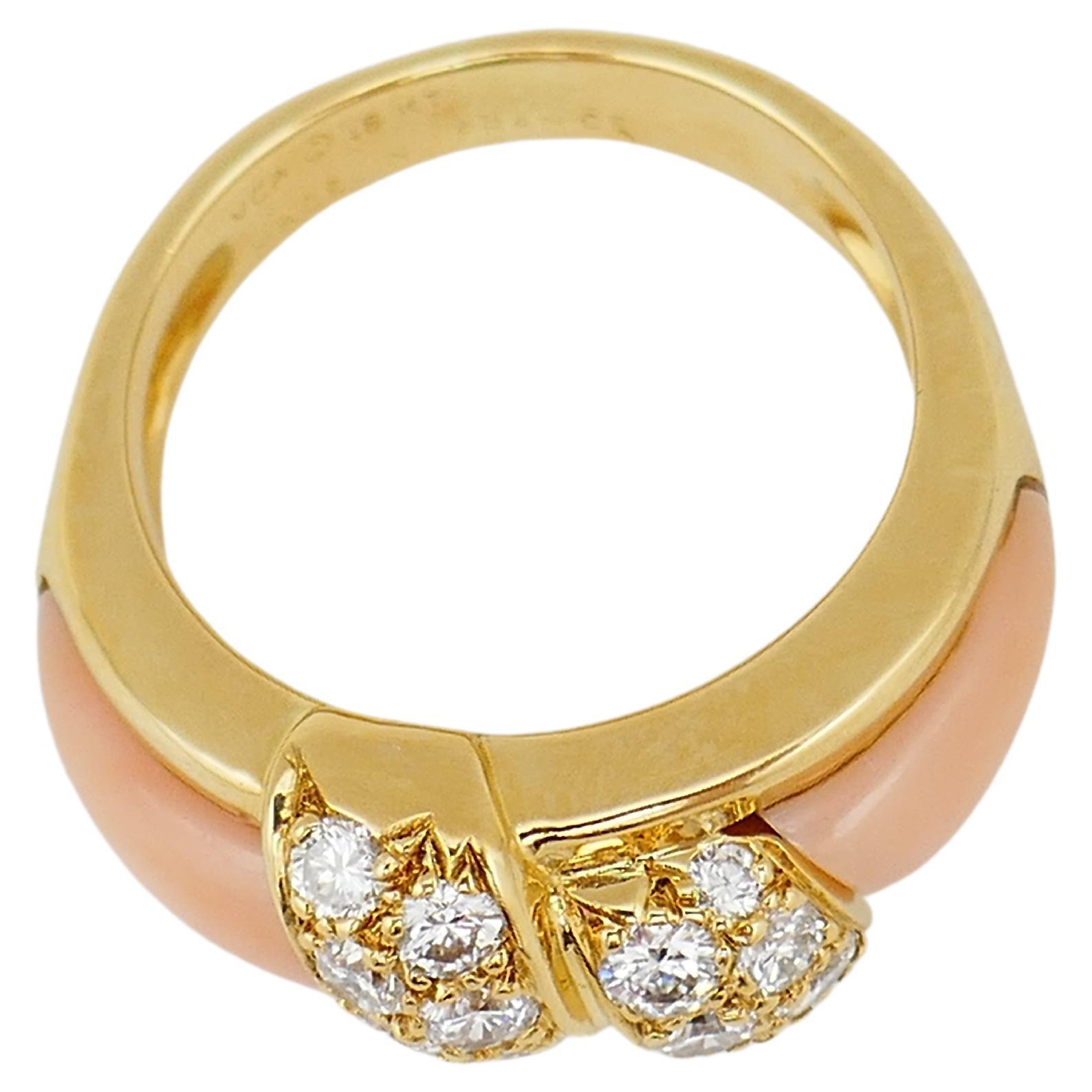 A gorgeous vintage ring by Van Cleef & Arpels. Made of 18k gold, coral and diamond. Diamonds are round brilliant cut, total carat weight is 0.36 points. 
Stamped with VCA maker's mark, French marks and written country of origin (France), a hallmark