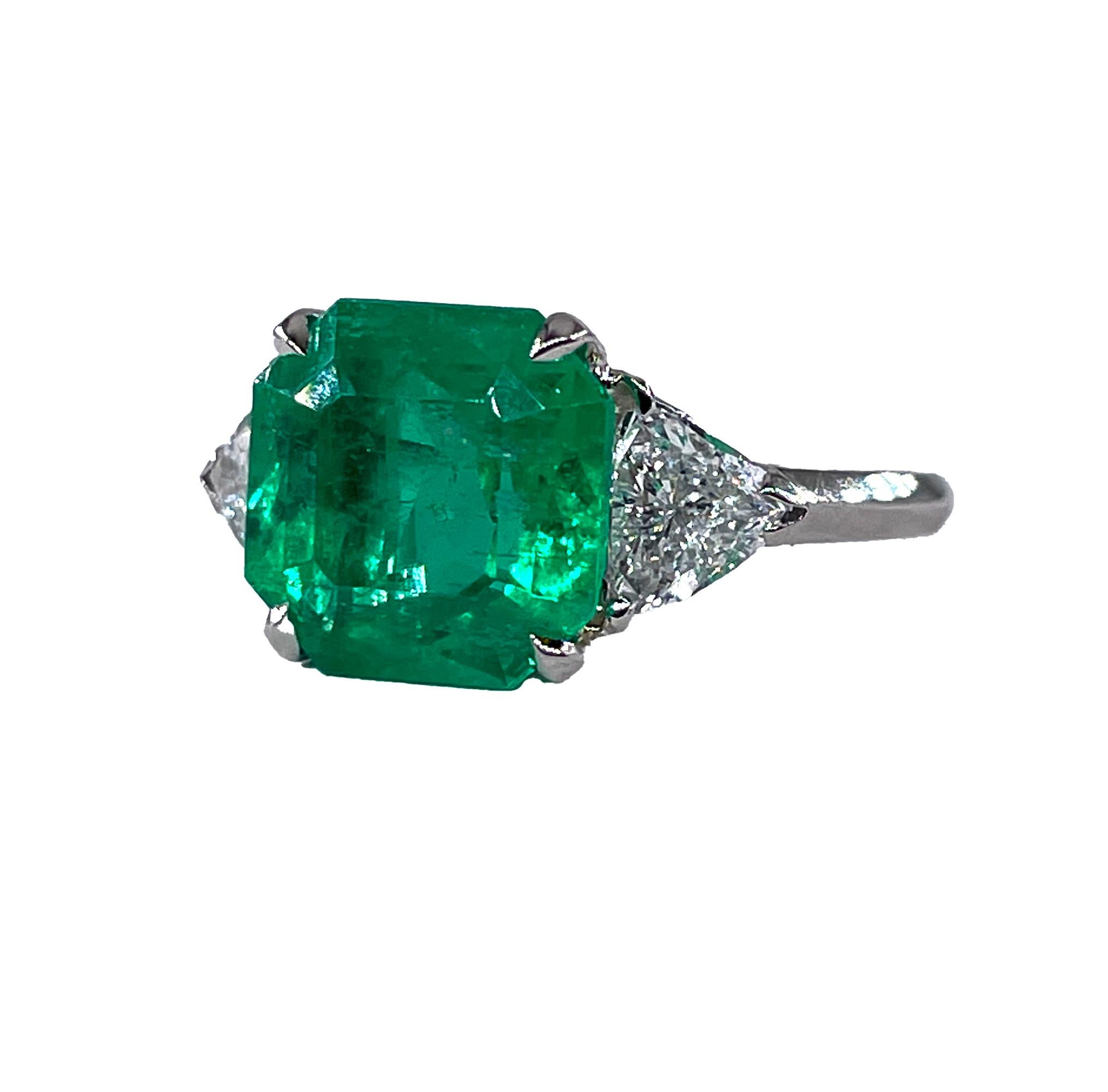 A Breathtaking Estate Vintage HANDMADE GIA certified 5.28ct Colombian Green Emerald and Diamond Three-Stone Platinum (tested) Ring signed by Van Cleef and Arpels.

The Prong Set Emerald cut Colombian Green Emerald is GIA Certified 3.58ct with