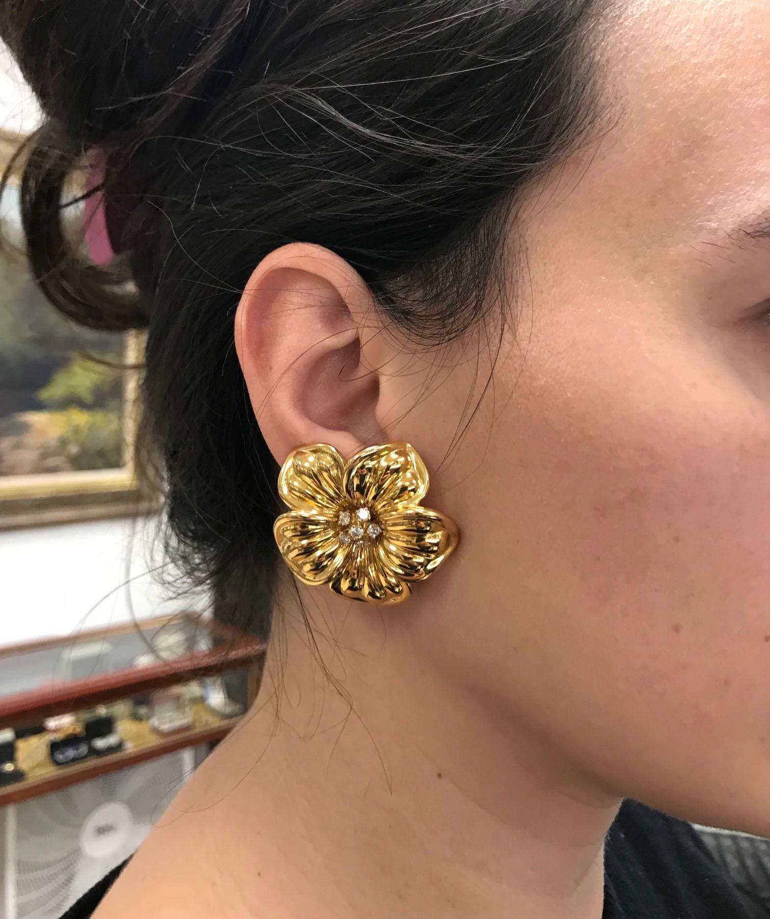 A gorgeous pair of vintage (c. 1980s) floral earrings by Van Cleef & Arpels, from Magnolia collection. Made of 18k gold, featuring round cut diamonds. Total carat weight is 1.01 ct. 
Stamped with VCA maker's mark, a hallmark for 18k gold and diamond