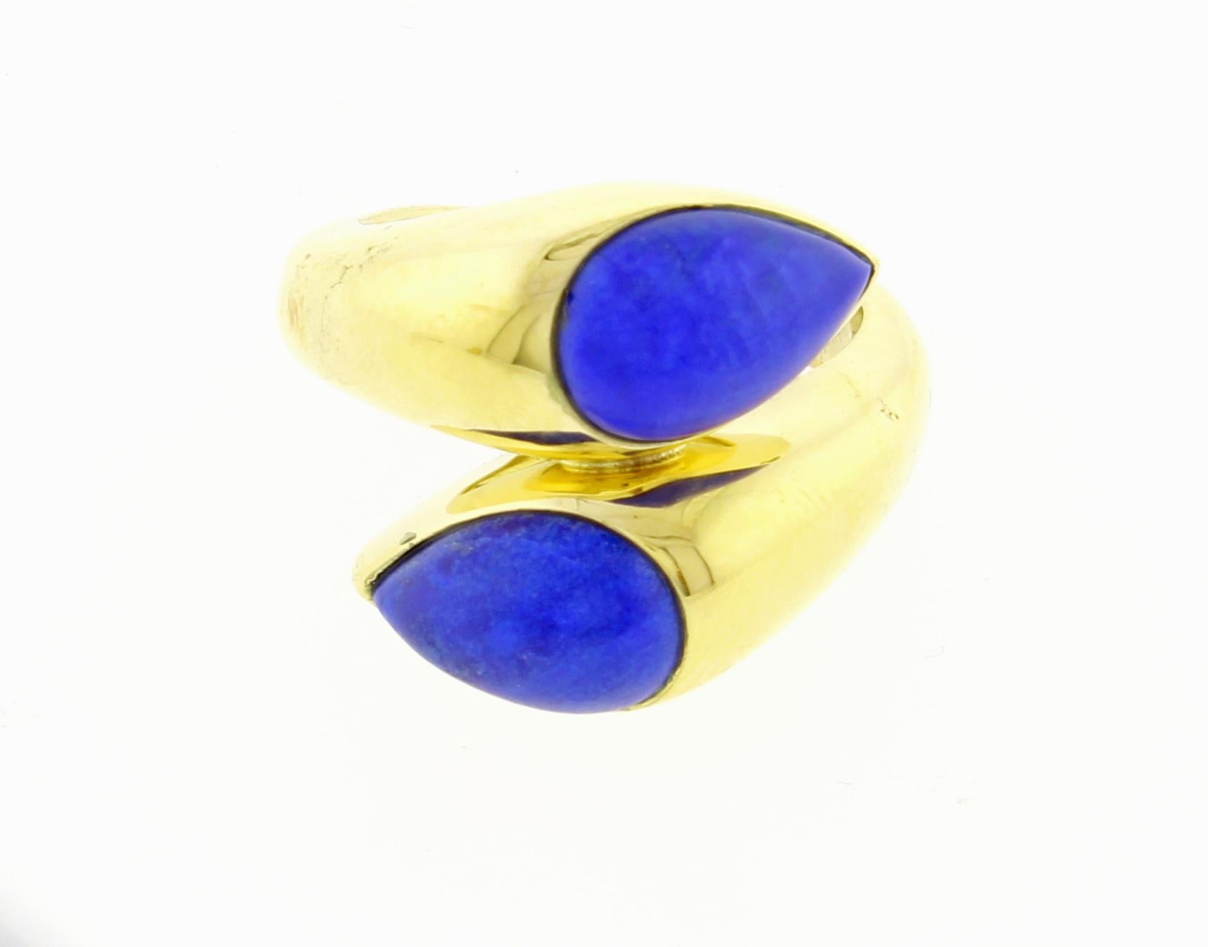 From Van Cleef & Arpels a twin pear shape Lapis ring. Signed  VCA NY
♦ Designer: Van Cleef & Arpels
♦ Metal: 18 karat
♦  Lapis Lazuli 11 X 7.5mm
♦ Circa 1975
♦ Size 5, 
♦ Packaging: Pampillonia presentation box 
♦ Condition: Excellent , pre-owned
♦