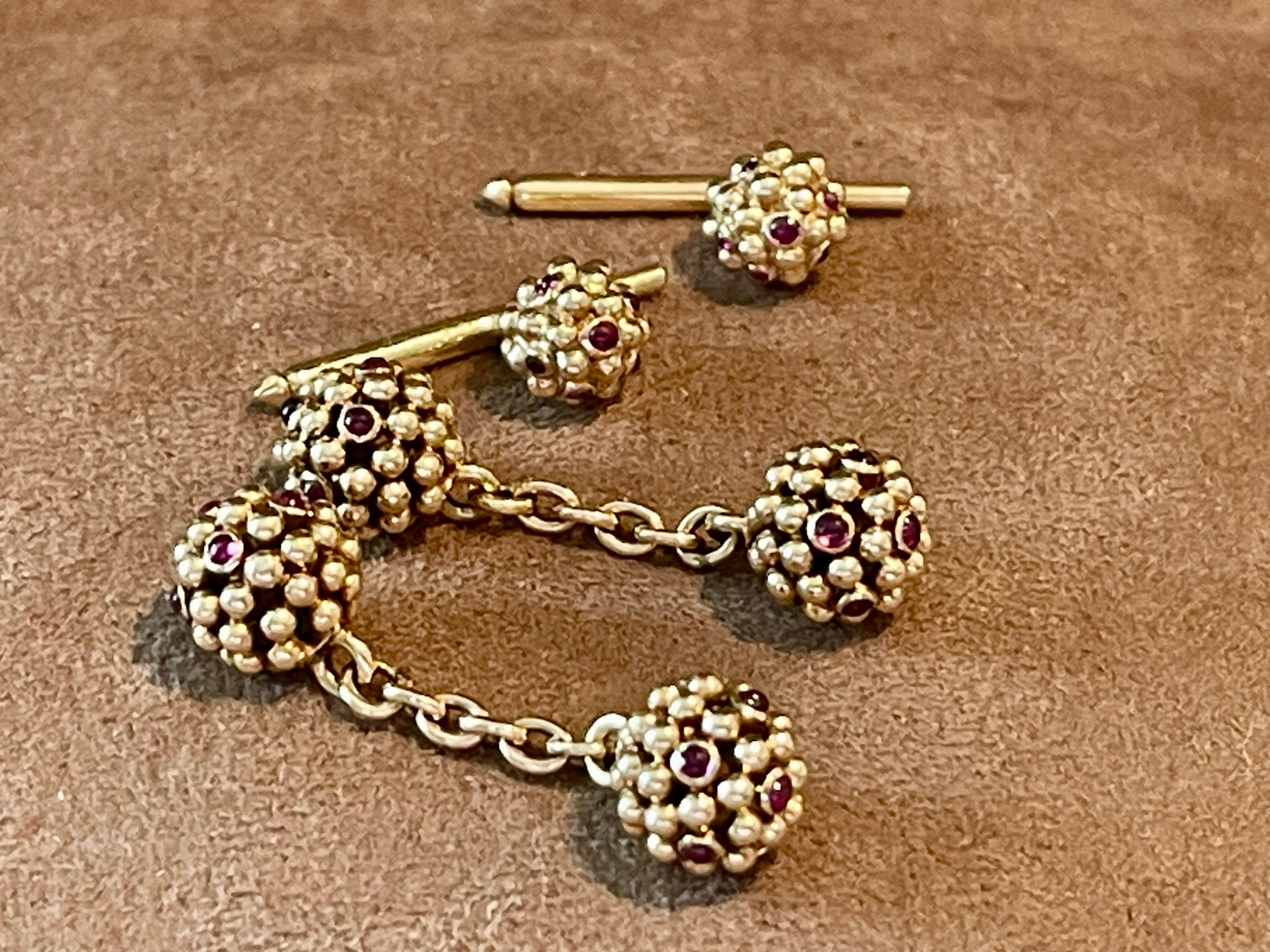 Designed as chain link-style cufflinks terminating with gold spheres set randomly throughout with round Ruby Cabochons. 24 cabochons Round cut genuine rubies adorn these Van Cleef & Arpels cuff links, bezel set, weighing approx 0.80 carats connected