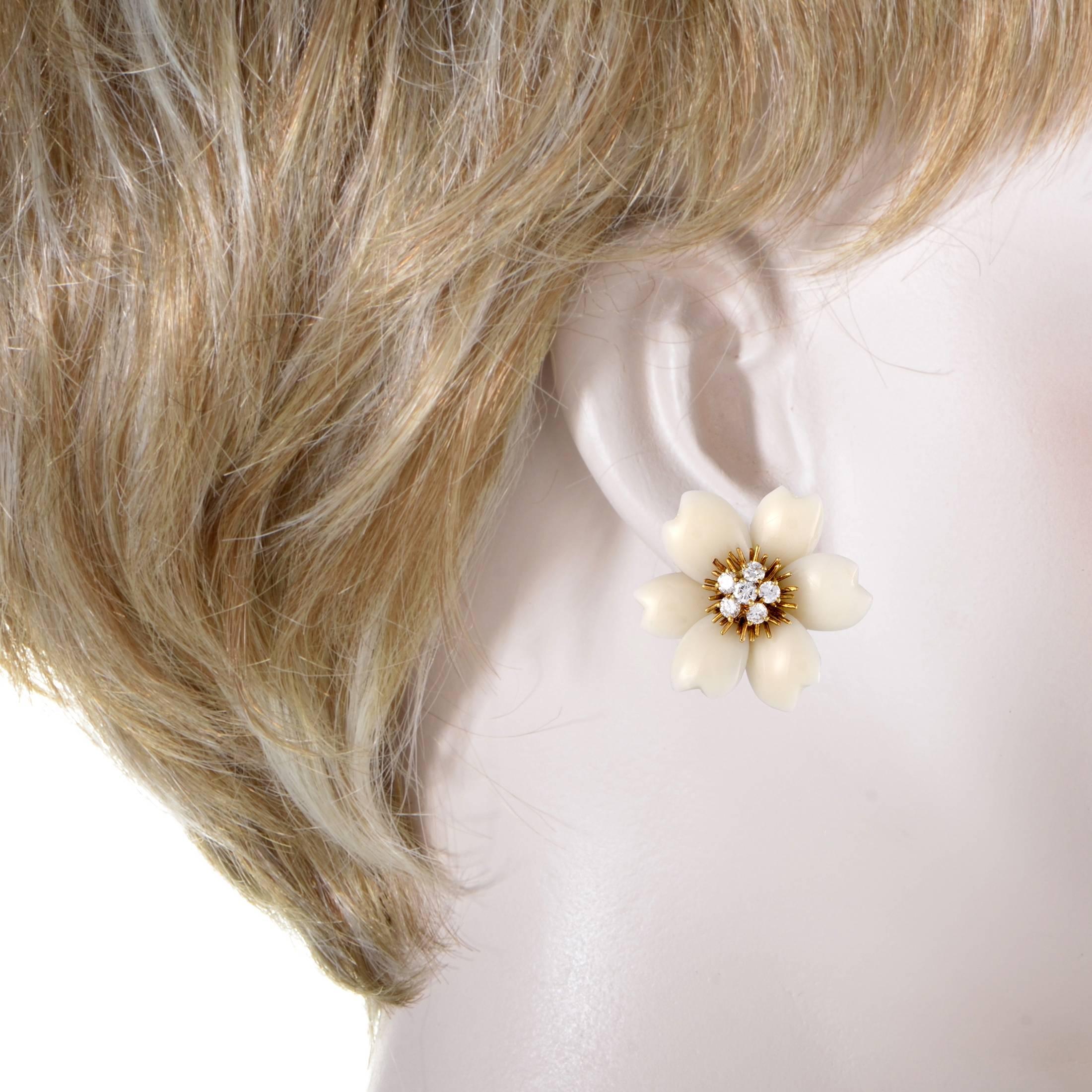 These stunning clip-on earrings by Van Cleef & Arpels emanate beauty and style. Made in shimmering 18K yellow gold, the attractive floral earrings have sparkling diamonds in the center and elegant white coral petals that accentuate the luxurious