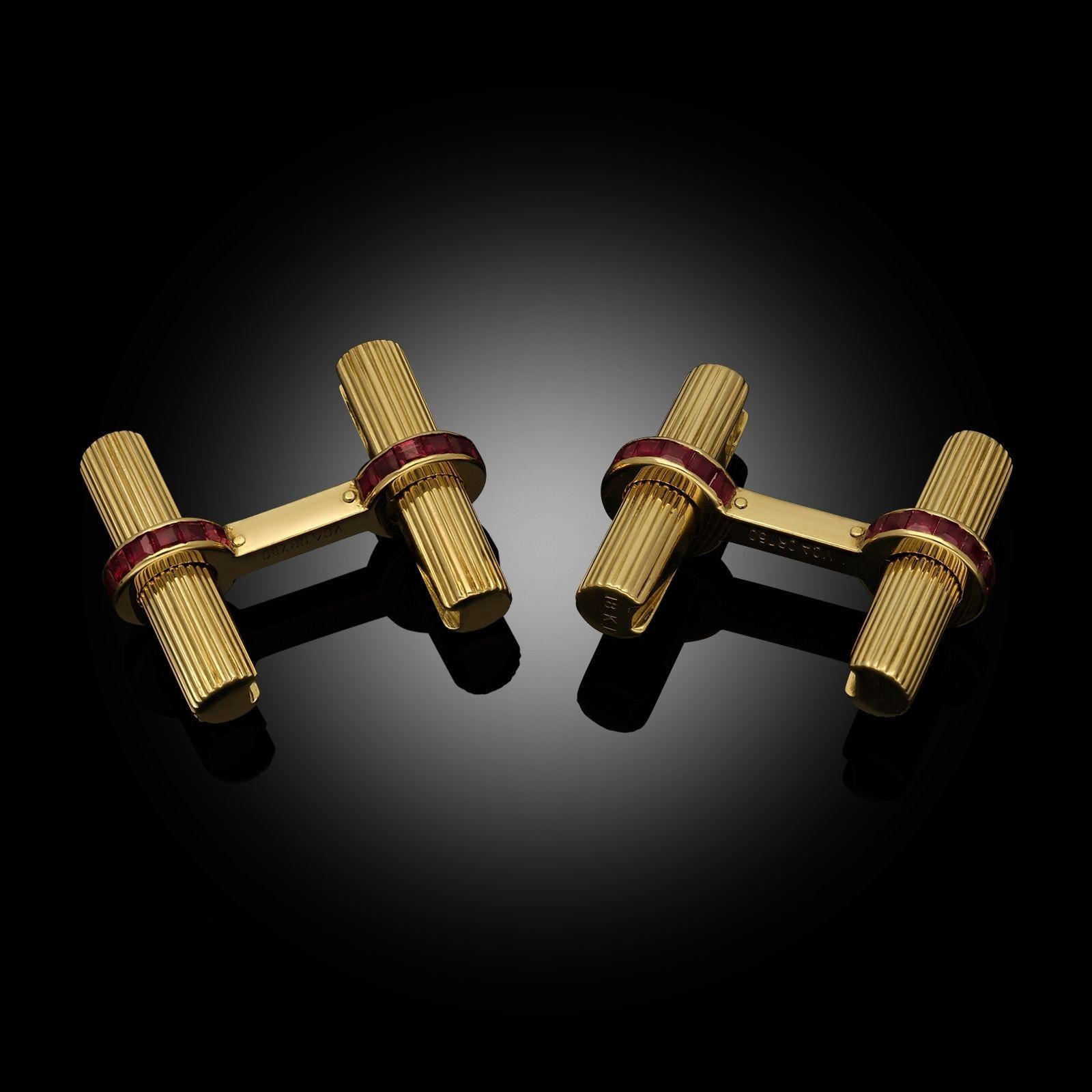 A pair of ruby and yellow gold double sided baton cufflinks by Van Cleef & Arpels, c.1970. The batons are designed as fluted cylindrical batons in 18ct yellow gold, each terminal of the connecting bars set with channel-set calibrated ruby. To wear,