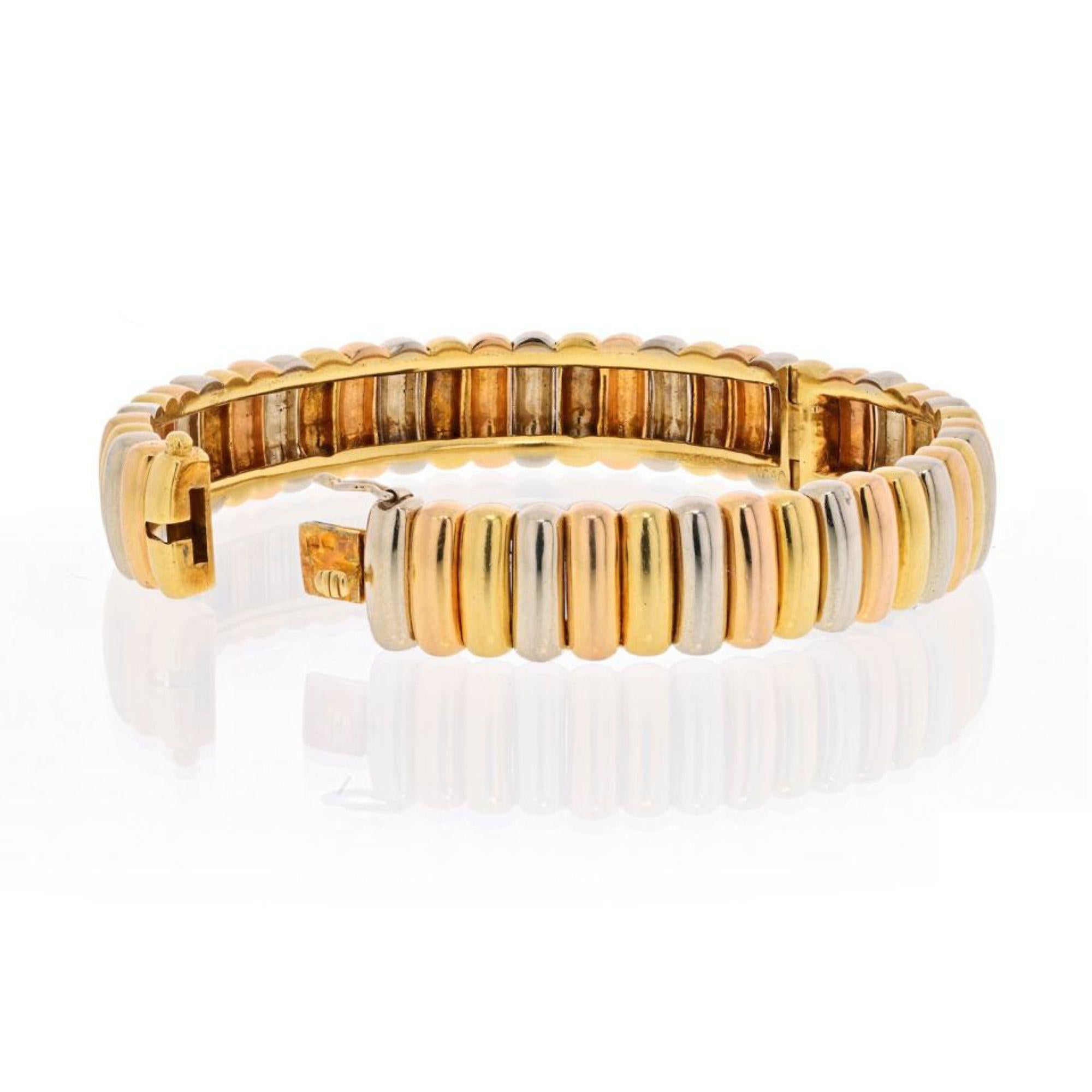 Vintage Van Cleef & Arpels Tri-color, 18K  white, rose and yellow gold fluted bangle bracelet. The articulated bangle of fluted design, length approximately 6.5 inches. French assay mark for gold. Stamped with French assay mark for 18 carat gold to