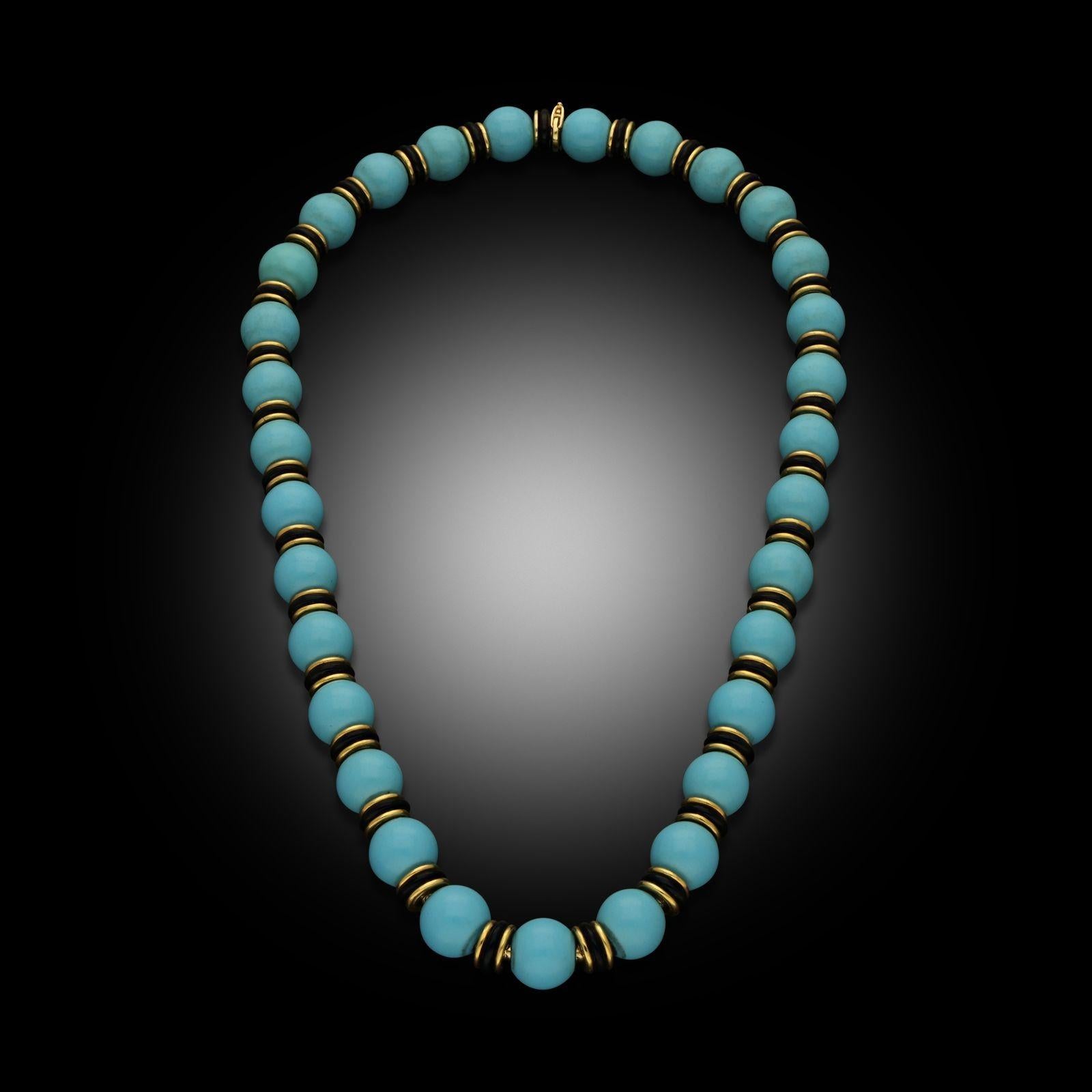 A vintage turquoise, onyx & yellow gold necklace by Van Cleef & Arpels, circa 1965. This necklace is designed as a single row of turquoise beads with polished black onyx rondelles and 18ct yellow gold spacers, all threaded onto a articulated 18ct
