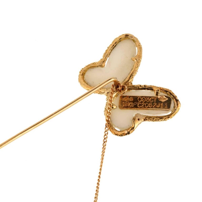 A stunning butterfly brooch by Van Cleef & Arpels set with beautiful white coral in 18k yellow gold.