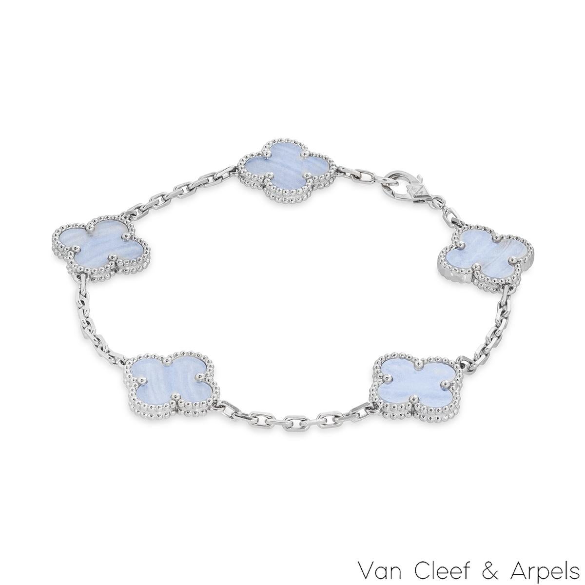 An 18k white gold bracelet from the Vintage Alhambra collection by Van Cleef and Arpels. The bracelet is made up of 5 iconic clover motifs, each set with a beaded edge and a chalcedony inlay, set throughout the length of the chain. The bracelet