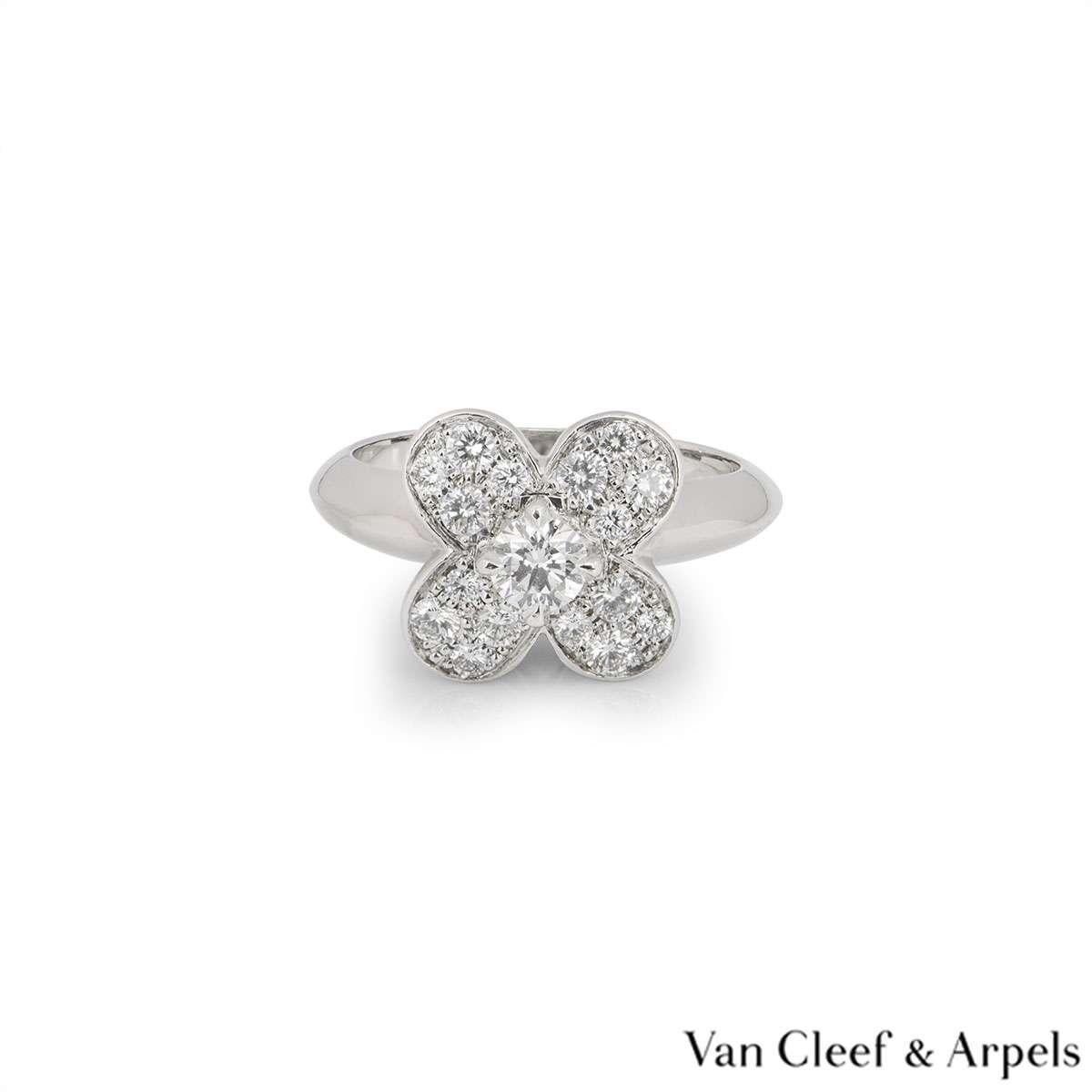 A stunning 18k white gold Alhambra ring by Van Cleef & Arples. The central flower motif is set with a single claw set round brilliant cut diamond weighing approximately 0.35ct. The petals of the flower are pave set with round brilliant cut diamonds