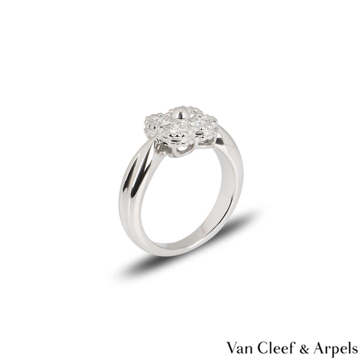 A lovely 18k white gold Van Cleef & Arpels diamond ring from the Alhambra collection. The central flower motif is set with 4 round round brilliant cut diamonds in a pave setting weighing approximately 0.28ct. The ring is currently a size UK E / EU
