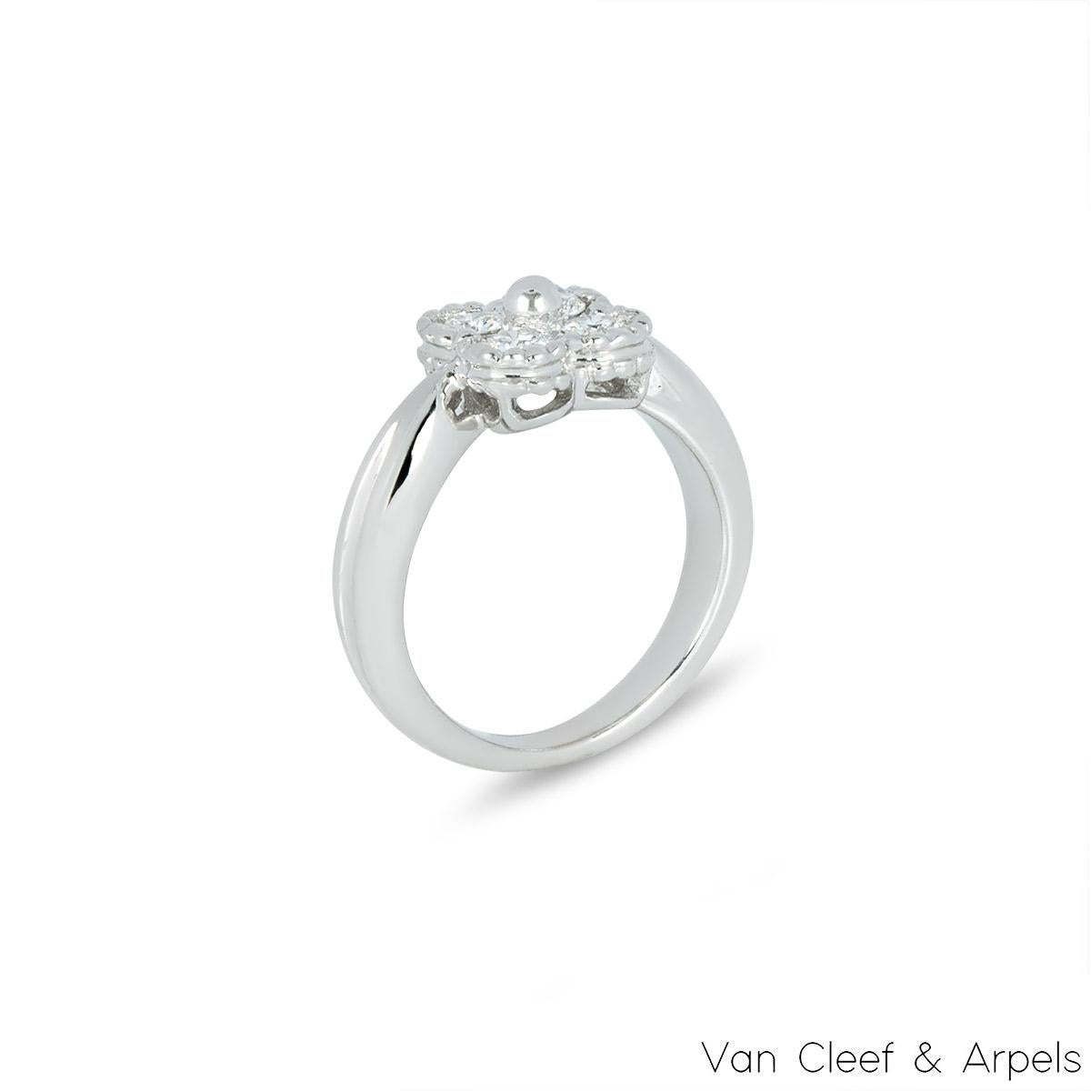 A lovely 18k white gold Van Cleef & Arpels diamond ring from the Alhambra collection. The central flower motif is set with 4 round round brilliant cut diamonds in a pave setting weighing approximately 0.28ct. The ring is currently a size UK E / EU