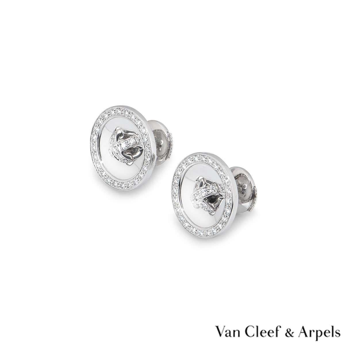 A pair of 18 carat white gold diamond earrings by Van Cleef & Arpels. The button motif earrings are set with round brilliant cut diamonds in the centre and around the outer edge. There are 66 diamonds with a total weight of approximately 0.39