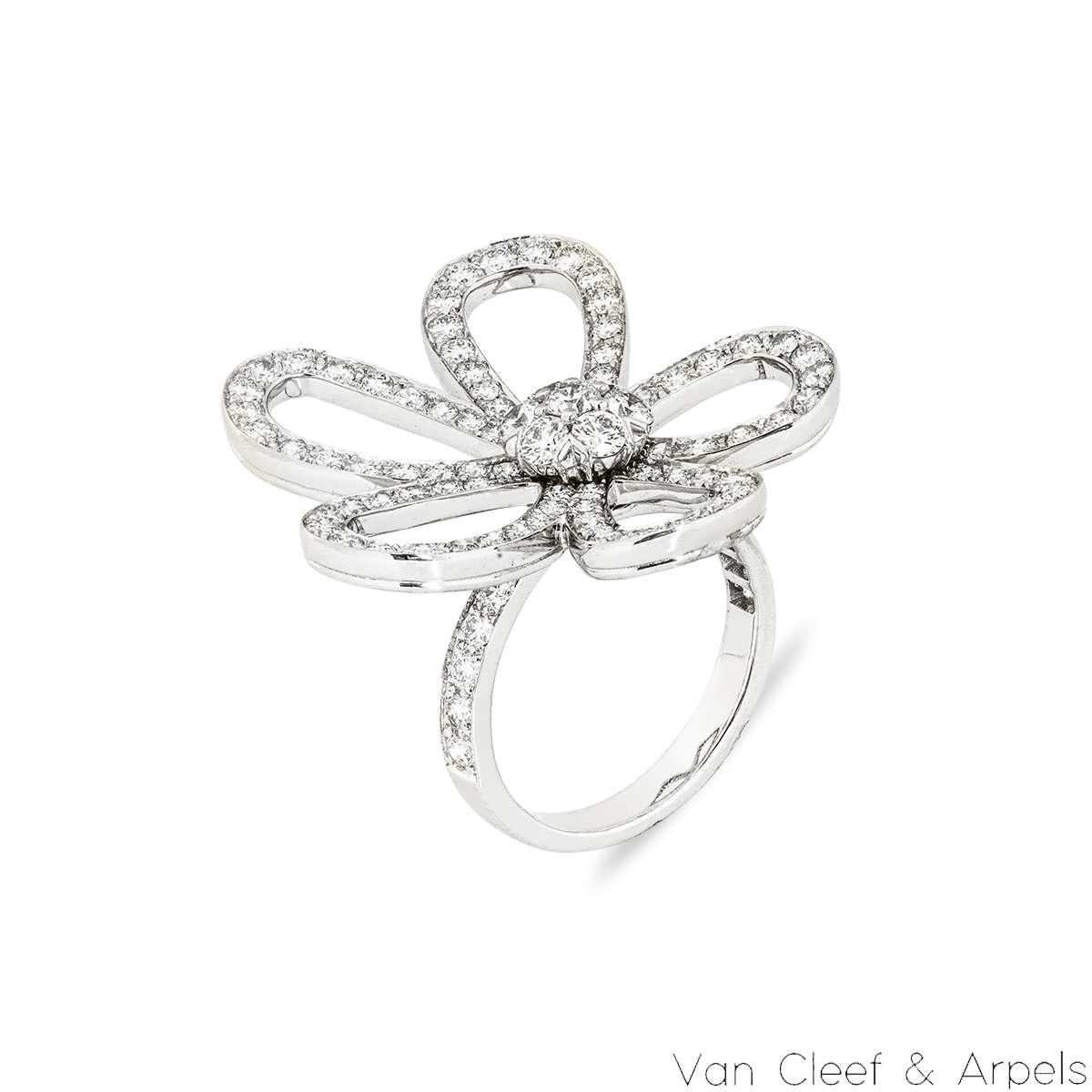 An 18k white gold and diamond ring by Van Cleef & Arpels from the Flowerlace collection. The ring comprises of an openwork flower set with round brilliant cut diamonds in a pave setting on the petals and round brilliant cut diamonds in the centre.