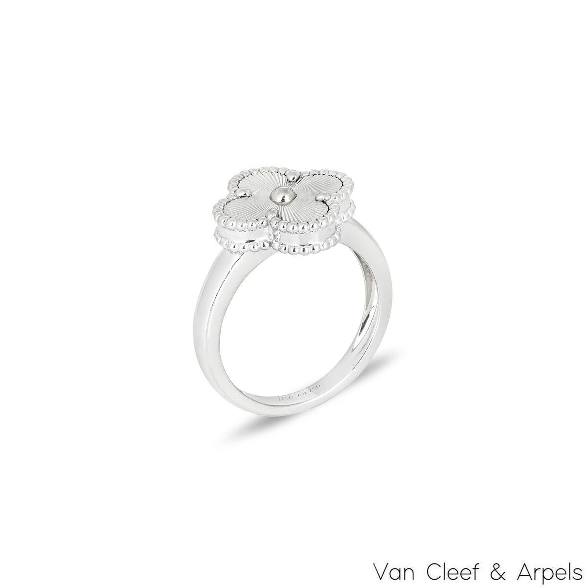 An 18k white gold ring by Van Cleef & Arpels from the Vintage Alhambra collection. The ring features the iconic 4-leaf clover motif with a guilloche inlay, complemented by a beaded edge. The ring is a UK size P/ EU size 56/ US size 7.5 and has a