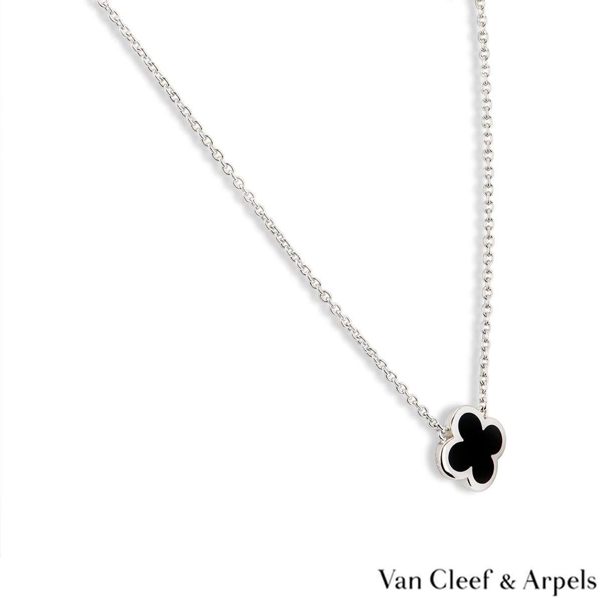 An 18k white gold pendant from the Pure Alhambra collection by Van Cleef & Arpels. The pendant features a four leaf clover motif with a black onyx inlay and a polished outer edge. The pendant measures 1.5cm in width and comes on an original 18 inch