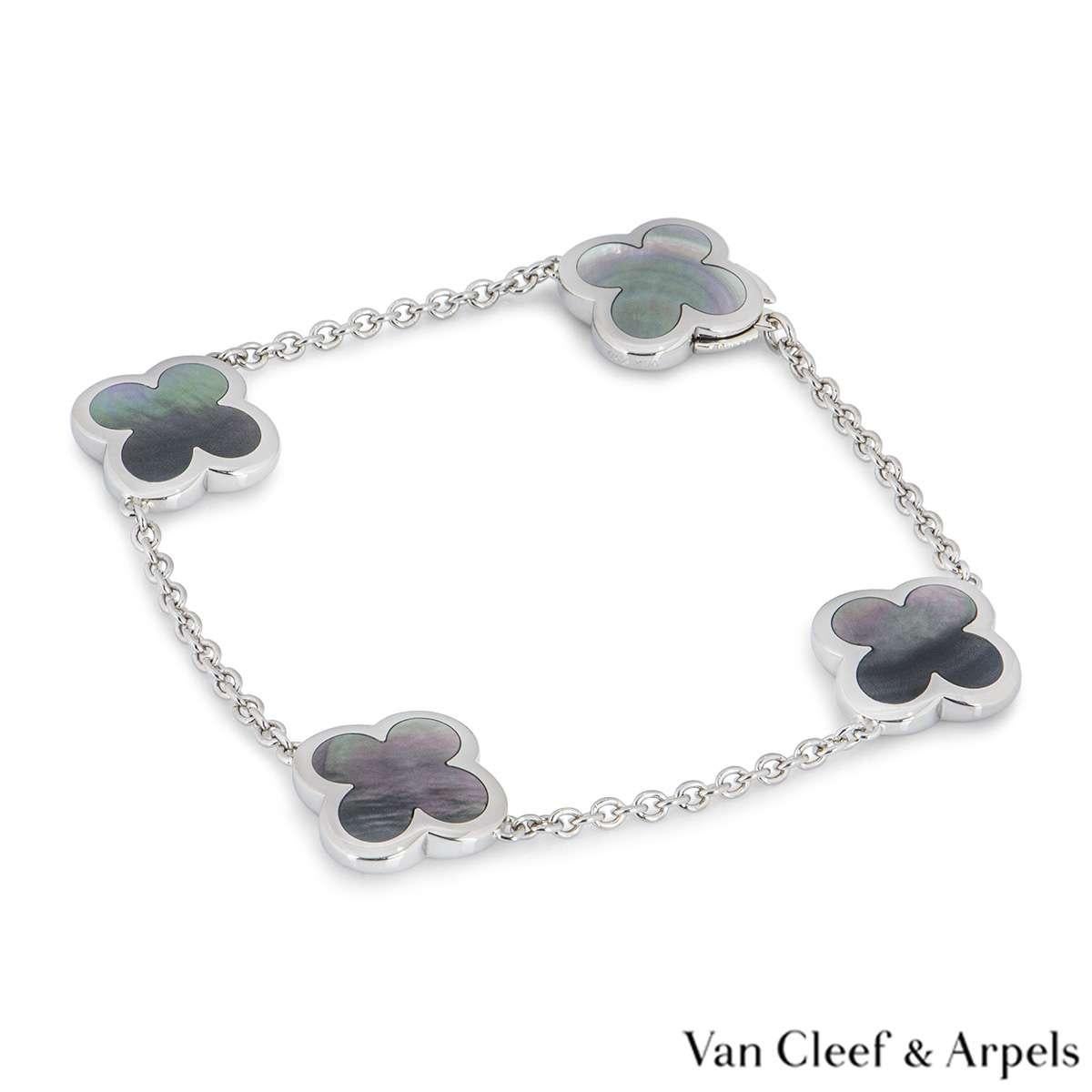 An 18k white gold Pure Alhambra bracelet by Van Cleef & Arpels. The bracelet is composed of 4 iconic four leaf clover motifs, set to the centre with grey mother of pearl inlays and a polished outer edge. The bracelet measures 7 inches in length and