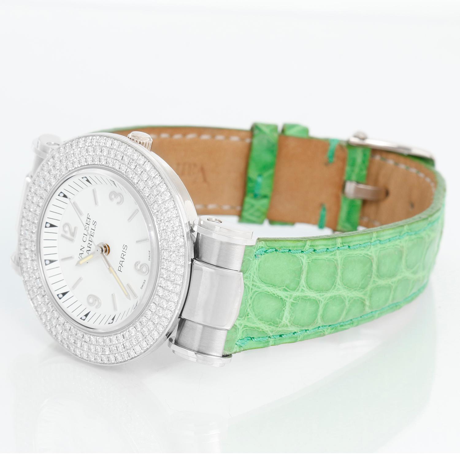 Van Cleef & Arpels White Gold Roma Diamond Ladies Watch - Quartz. 18K White gold with pave set diamond bezel ( 33mm). White dial with stick hour markers and Arabic numerals. Green Van Cleef & Arpels strap with tang buckle. Pre-owned with custom box .