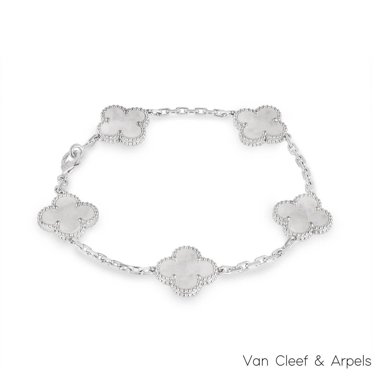 A classic 18k white gold mother of pearl bracelet by Van Cleef and Arpels from the Vintage Alhambra Collection. The stylish bracelet is made up of 5 iconic 4-leaf clover motifs, each set with a beaded edge and mother of pearl inlay, set throughout