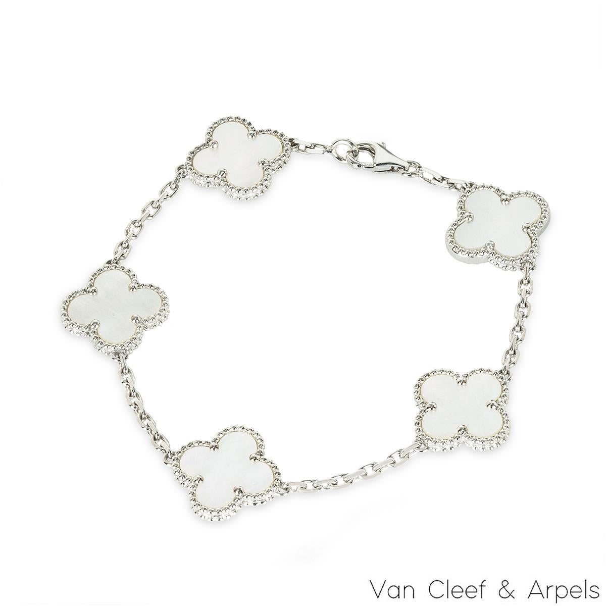 A classic 18k white gold mother of pearl bracelet by Van Cleef and Arpels from the Vintage Alhambra Collection. The stylish bracelet is made up of 5 iconic 4-leaf clover motifs, each set with a beaded edge and mother of pearl inlay, set throughout