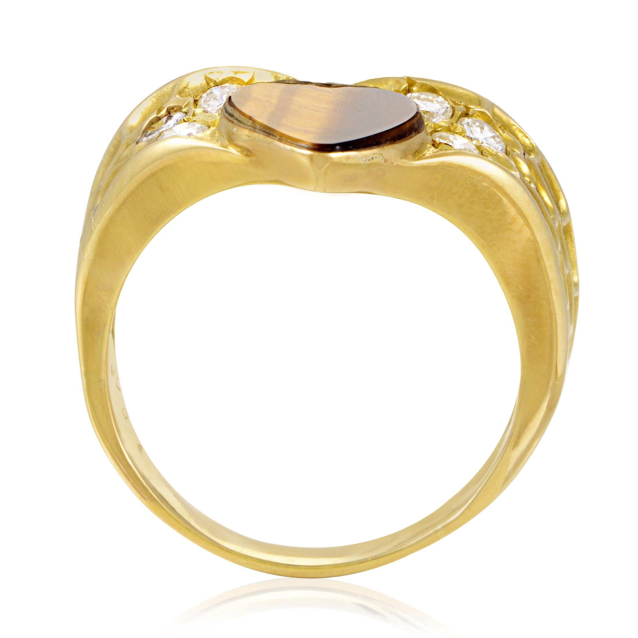 Neatly cut into a romantic shape of a heart while fascinatingly exhibiting its intriguing gradated color, the splendid tiger?s eye stone takes the central spot of this gorgeous 18K yellow gold ring from Van Cleef& Arpels that also boasts glistening