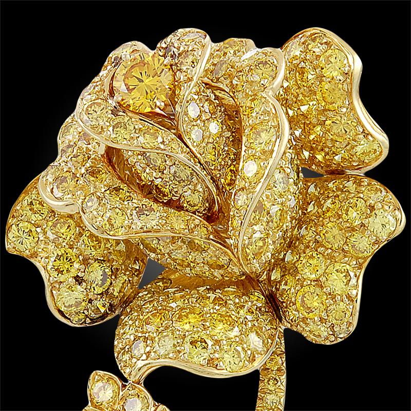 A resplendent piece by Van Cleef & Arpels, comprised of 218 fancy vivid yellow diamonds weighing approximately 25 carats VVS-VS,  finely set in 18k yellow gold and designed as a quintessentially feminine rose brooch.
Signed Van Cleef &