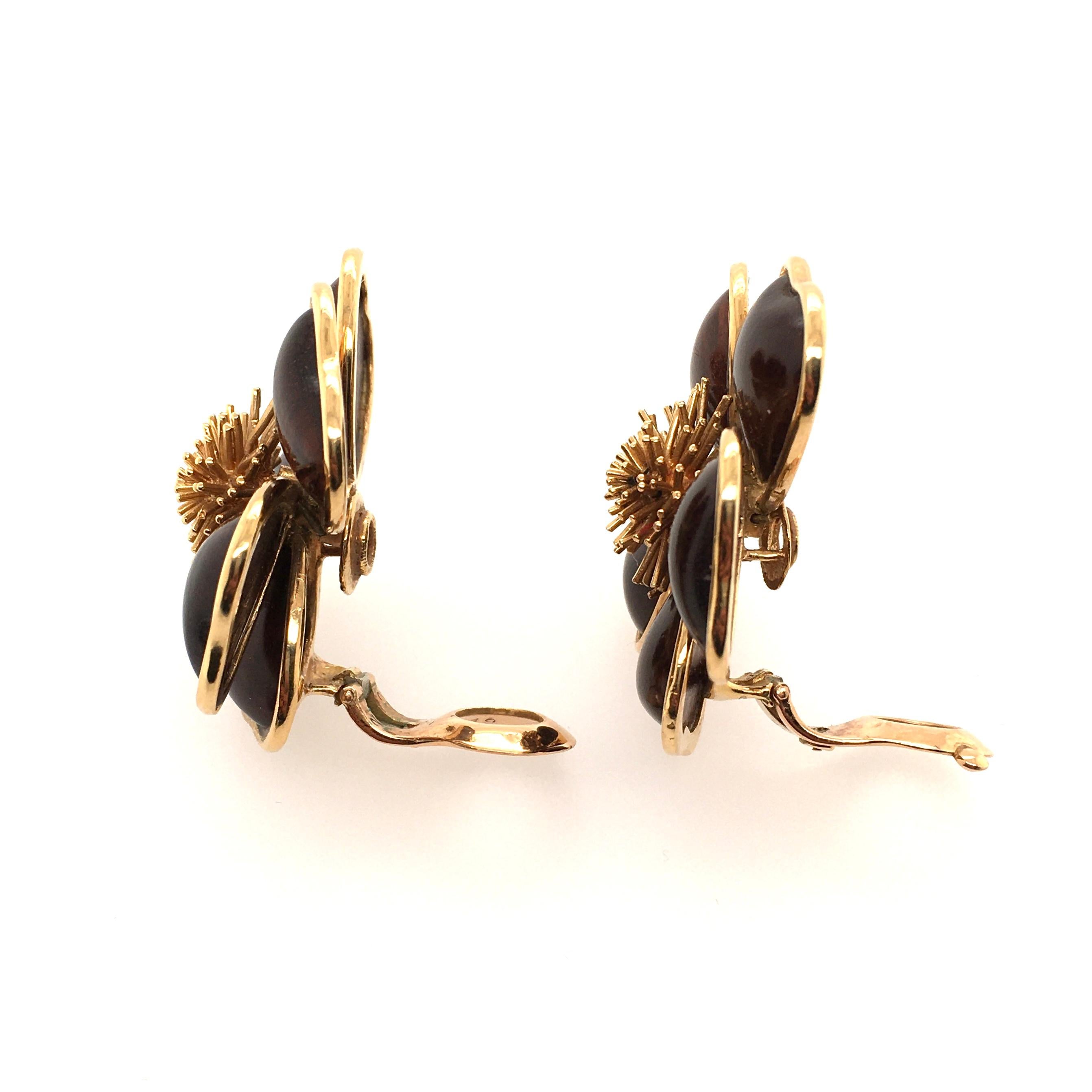 A pair of 18 karat yellow gold and wood Nerval earrings. Van Cleef & Arpels. Designed as a sculpted 18k gold flower with wooden petals, centering a gold spray. Diameter is approximately 1 inch, gross weight is approximately 31.8 grams. Stamped VCA,