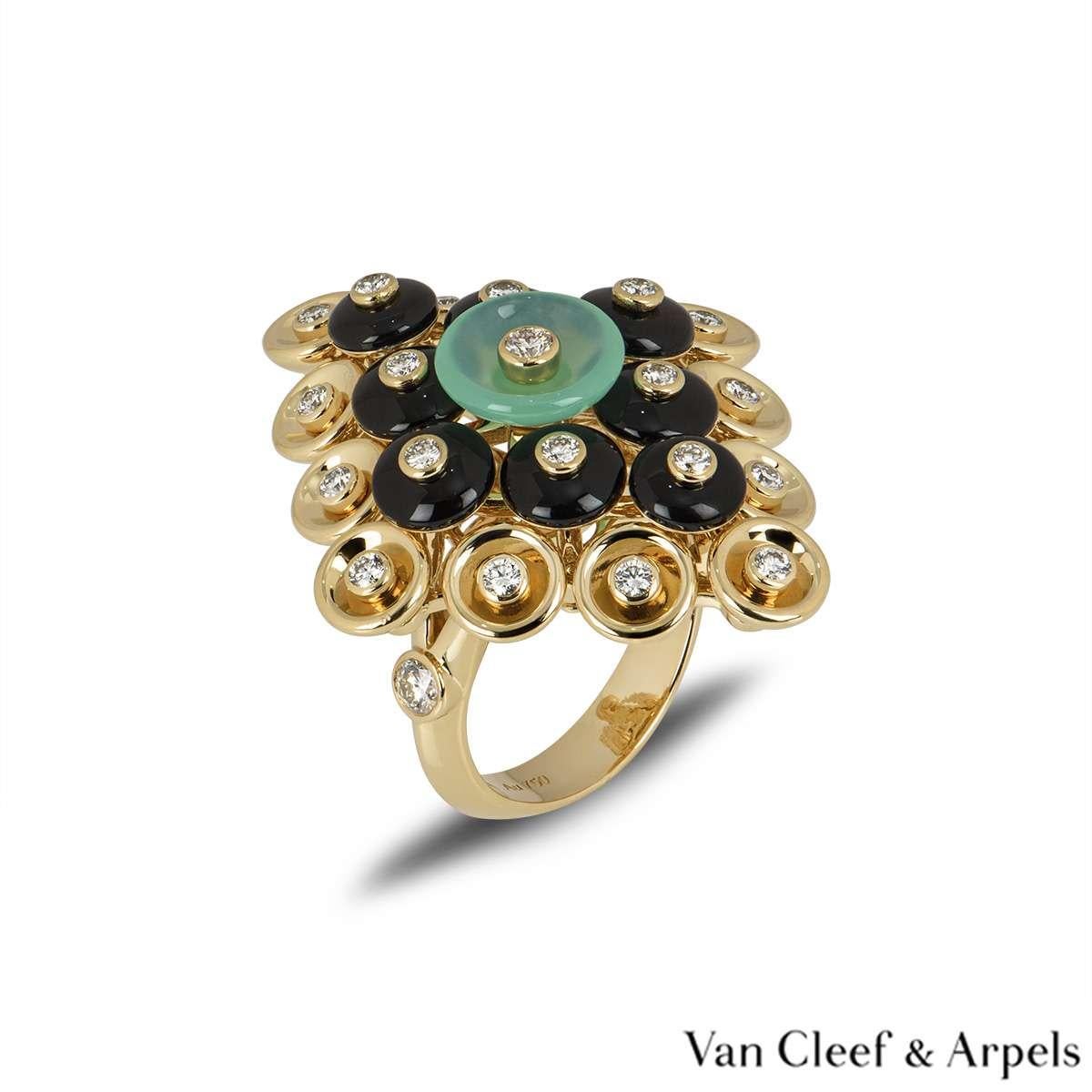 A unique dress ring from the Bouton d'or collection by Van Cleef & Arpels. The ring features a paillette design which includes diamonds, onyx and chrysoprase. The are a total of 23 diamonds totalling 0.68ct. The ring measures 2.8cm in width and
