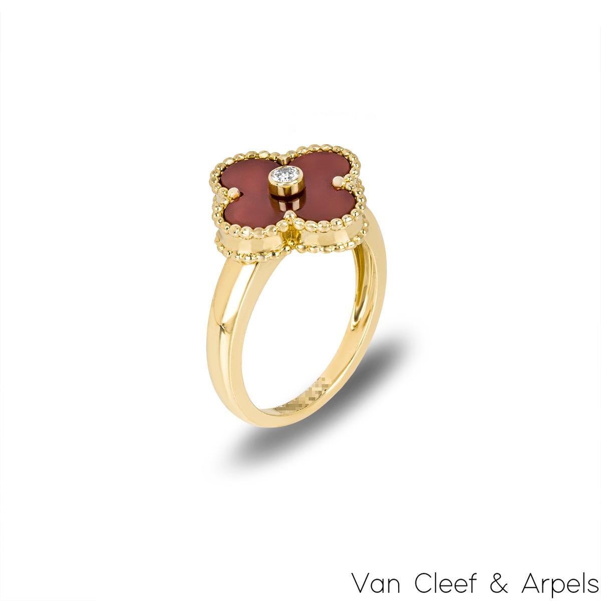A beautiful 18k yellow gold Van Cleef & Arpels ring from the Vintage Alhambra collection. The ring features a four leaf clover motif with a carnelian inlay, complemented by a beaded edge and a round brilliant cut diamond set to the centre weighing
