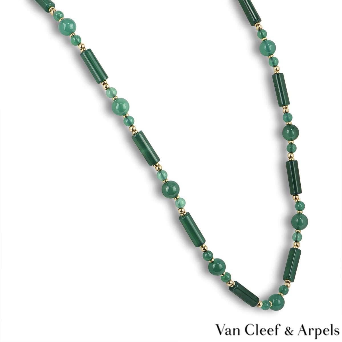 A beautiful 14k yellow gold necklace by Van Cleef & Arpels. The green chalcedony necklace is made up of 14 cylindrical beads and 41 ball beads alternating in size. The beads are separated by yellow gold intersections. The necklace measures 30 inches
