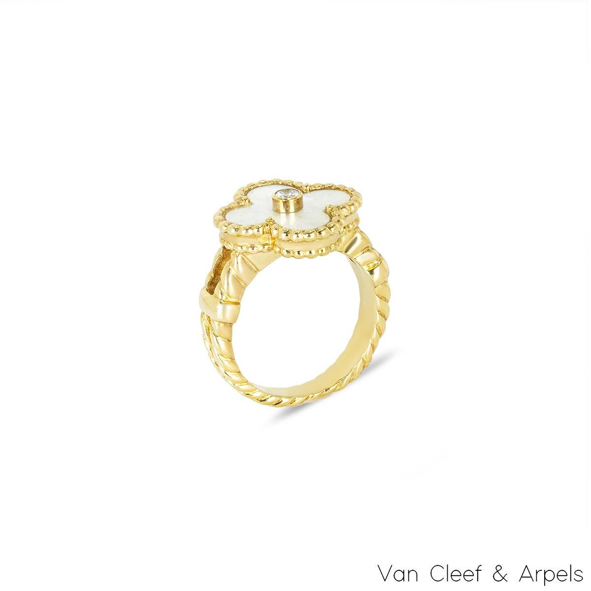 A beautiful 18k yellow gold Van Cleef & Arpels ring from the Alhambra collection. The ring is composed of a four leaf clover motif with a mother of pearl inlay, complimented by a beaded edge and a round brilliant cut diamond weighing approximately